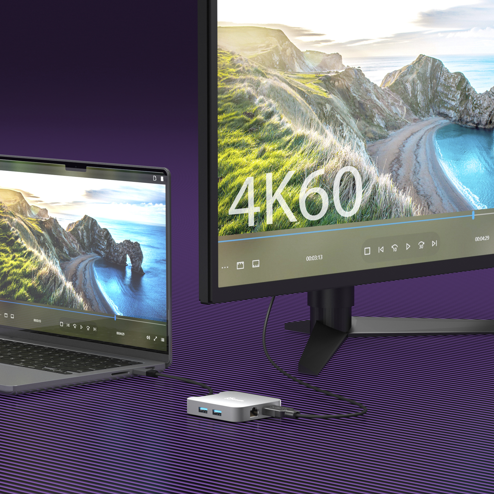 Ein Laptop und ein Monitor zeigen ein Landschaftsvideo. Ein Hub verbindet Laptop und Monitor mit 4K60.