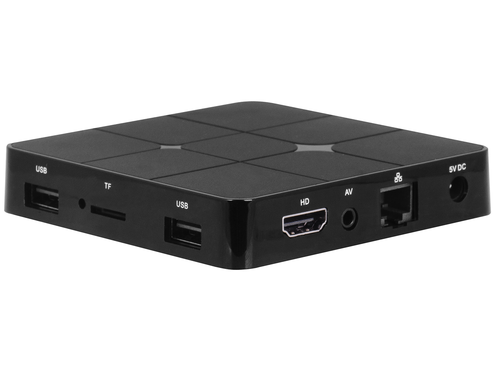 Caja multimedia negra con puertos: USB, TF, HD, AV, Ethernet y 5V CC. La superficie superior tiene cuadrados decorativos. Aislada en blanco.
