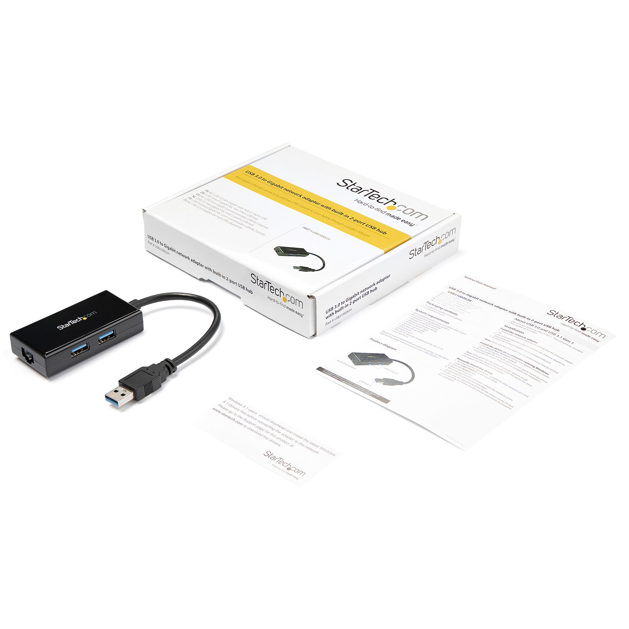 Eine weiße Box mit USB-Hub und Dokumentation liegt auf einer weißen Oberfläche.