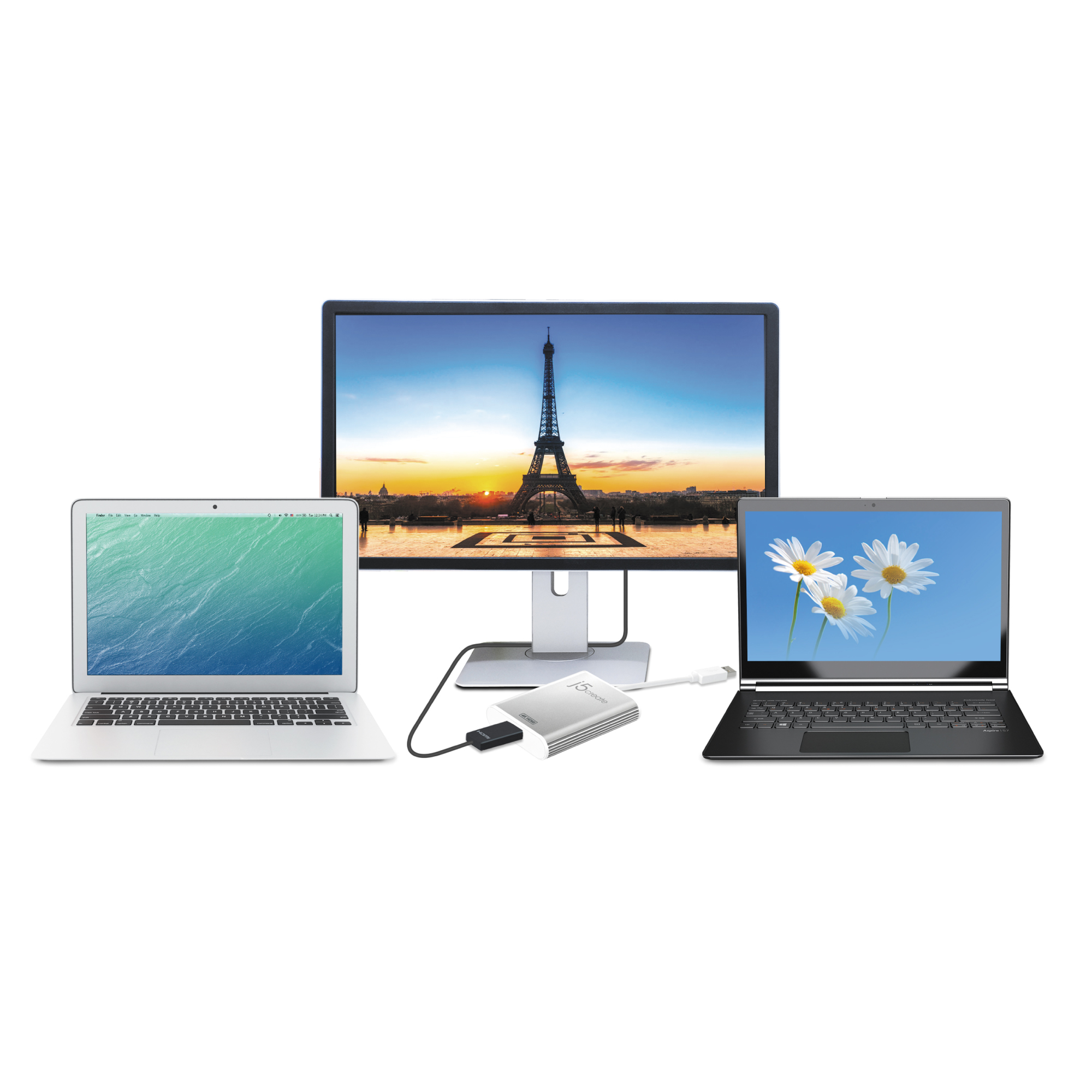Tres portátiles y un monitor con la Torre Eiffel. Un adaptador plateado conecta el monitor a los portátiles.