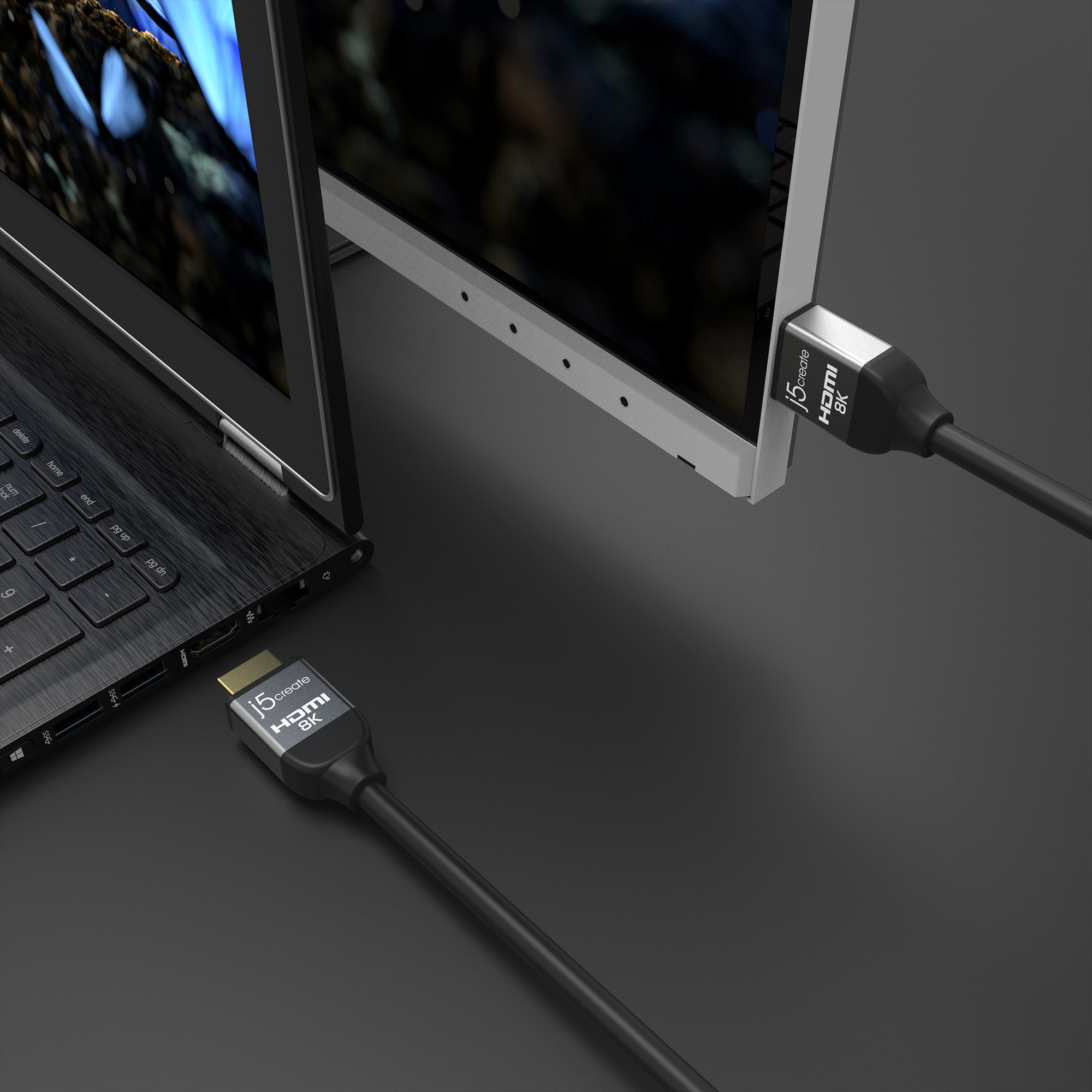 Ein Laptop, der über ein HDMI-Kabel mit einem Monitor verbunden ist, beide mit j5create HDMI 8K-Etiketten.