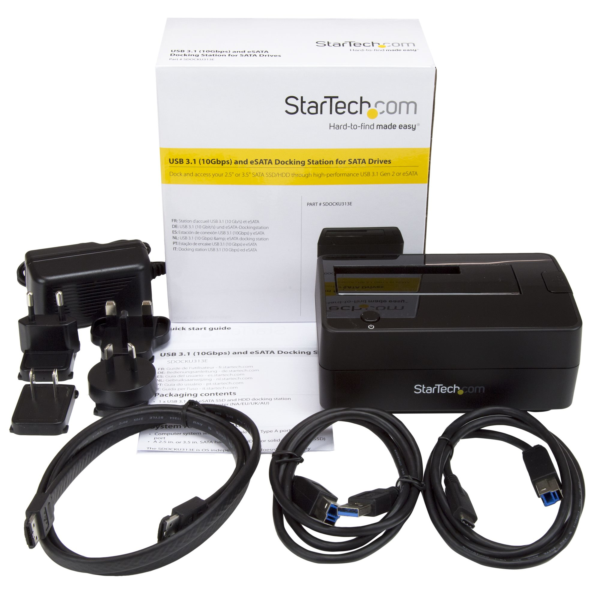 Ein Dockingstation-Kit mit Kabeln, Netzteil und verschiedenen Steckern auf weißer Oberfläche.