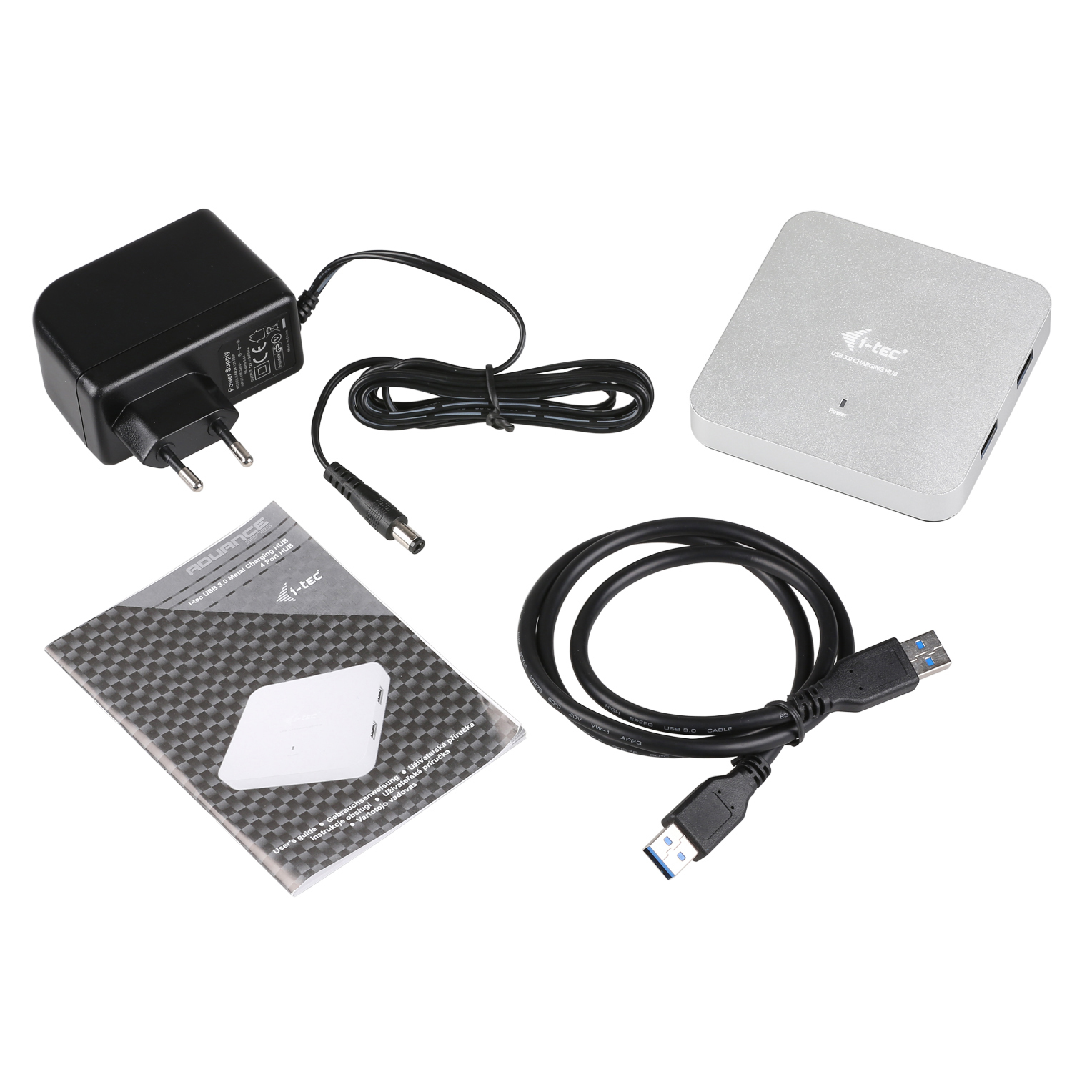 Draufsicht auf ein USB-Ladehub-Kit. Es umfasst einen Netzadapter, einen Hub, eine Anleitung und ein USB-Kabel, alles auf weißem Untergrund.