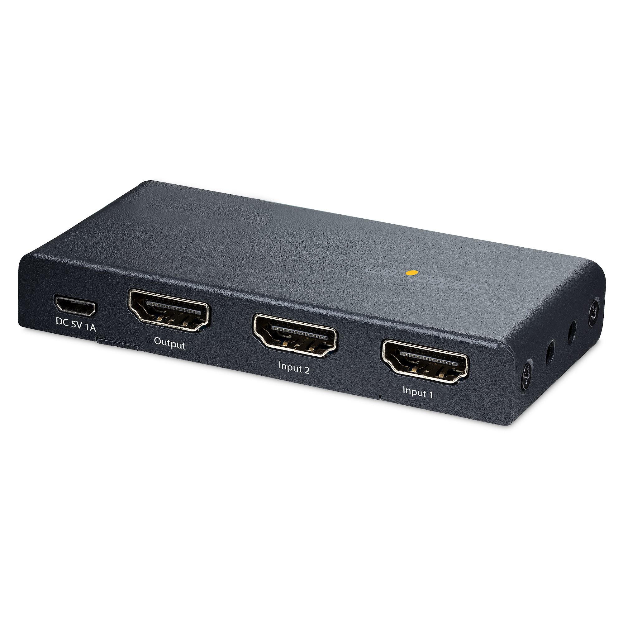 Conmutador HDMI negro con puertos de entrada y salida, etiquetados. También es visible un puerto DC 5V 1A. Fondo blanco.