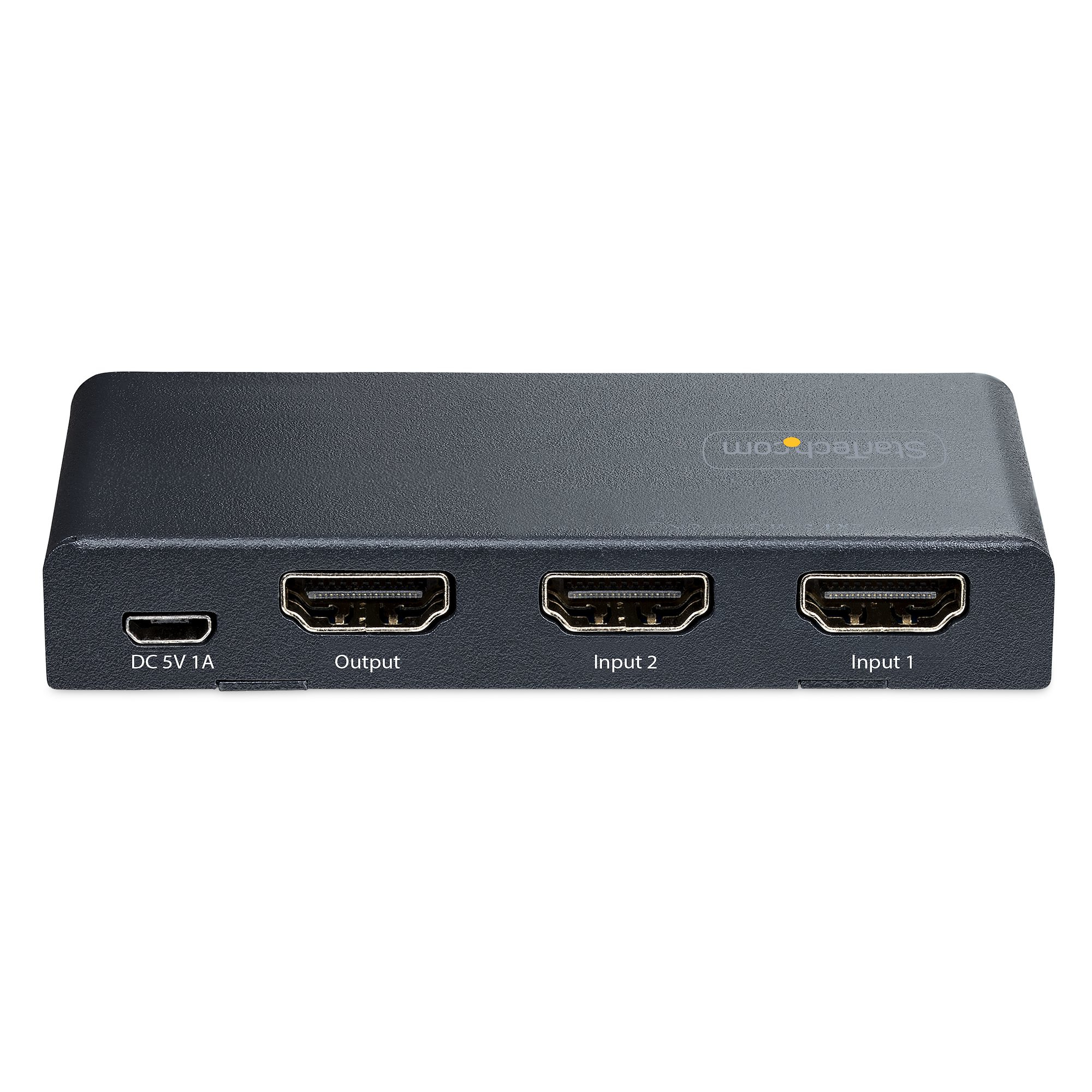 Un conmutador HDMI negro con tres puertos HDMI etiquetados como 'Output', 'Input 2' e 'Input 1'. Incluye puerto DC 5V 1A.