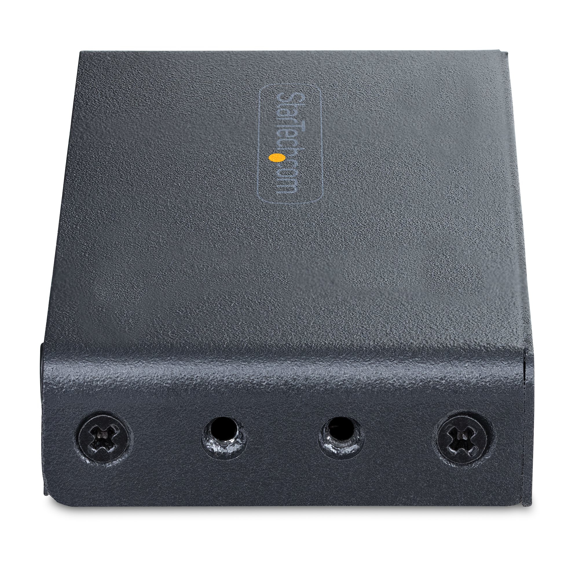Un dispositivo rectangular gris oscuro con el logotipo de Startech.com. Cuenta con orificios para tornillos en el frente y una superficie texturizada.