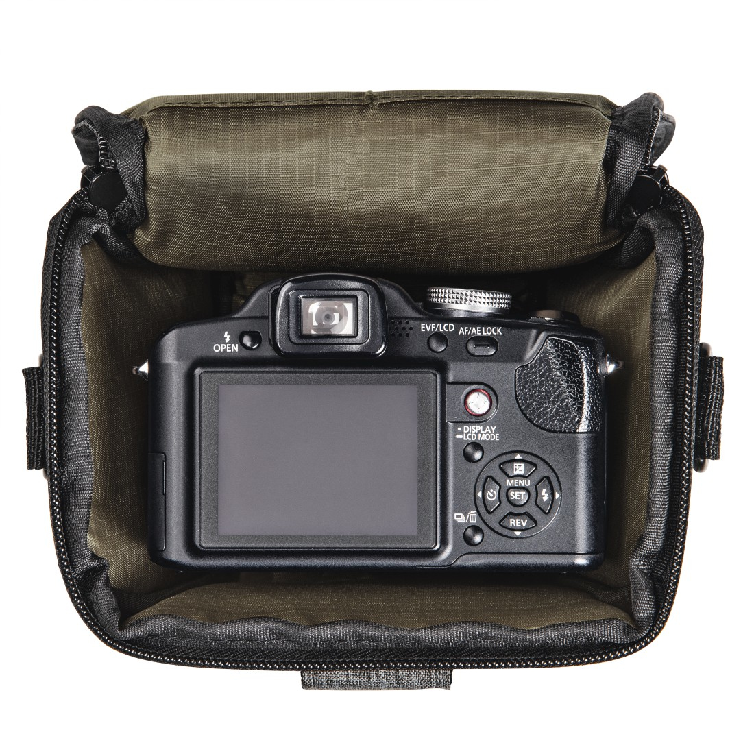 A black camera is inside an open olive green camera bag. The camera's screen faces outwards. The bag is on a white surface.