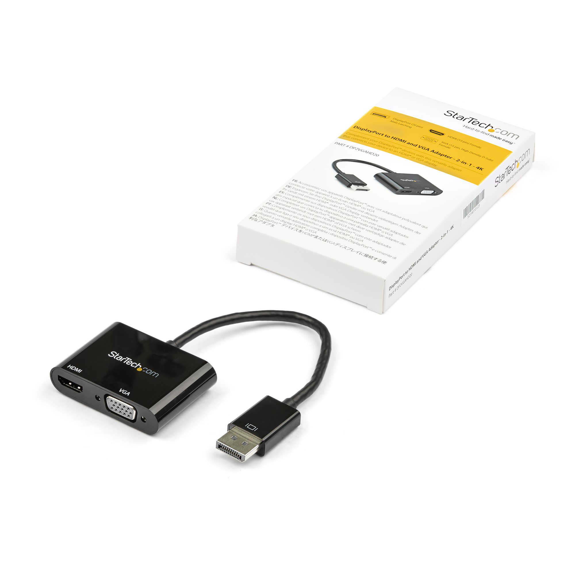 Un adaptador negro con puertos HDMI y VGA, un conector DisplayPort y una caja del producto.