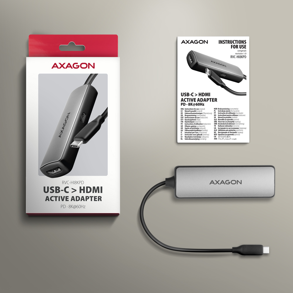 Adapter Axagon USB-C do HDMI w opakowaniu. Produkt i instrukcje na szarej powierzchni.