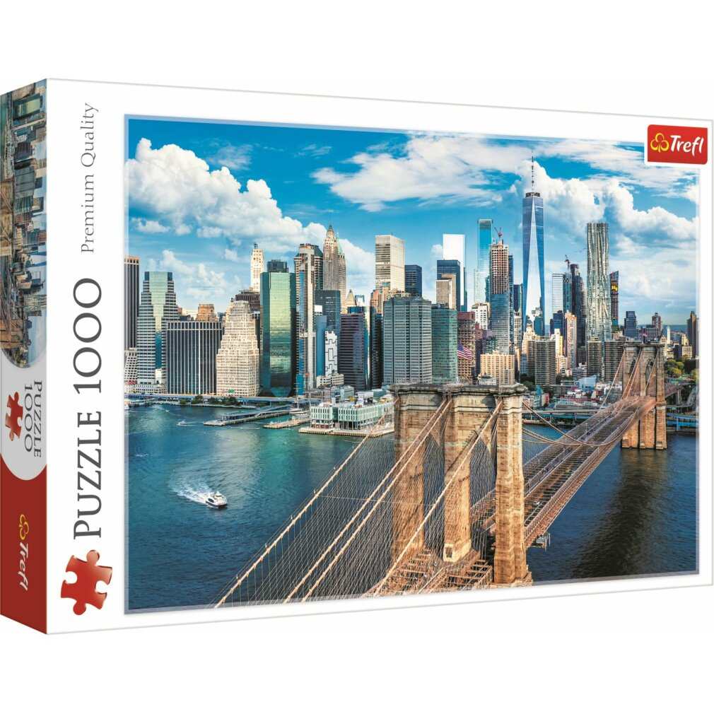 Eine Puzzleschachtel mit der Brooklyn Bridge und der Skyline von NYC, mit einem Boot auf dem Wasser und blauem Himmel.