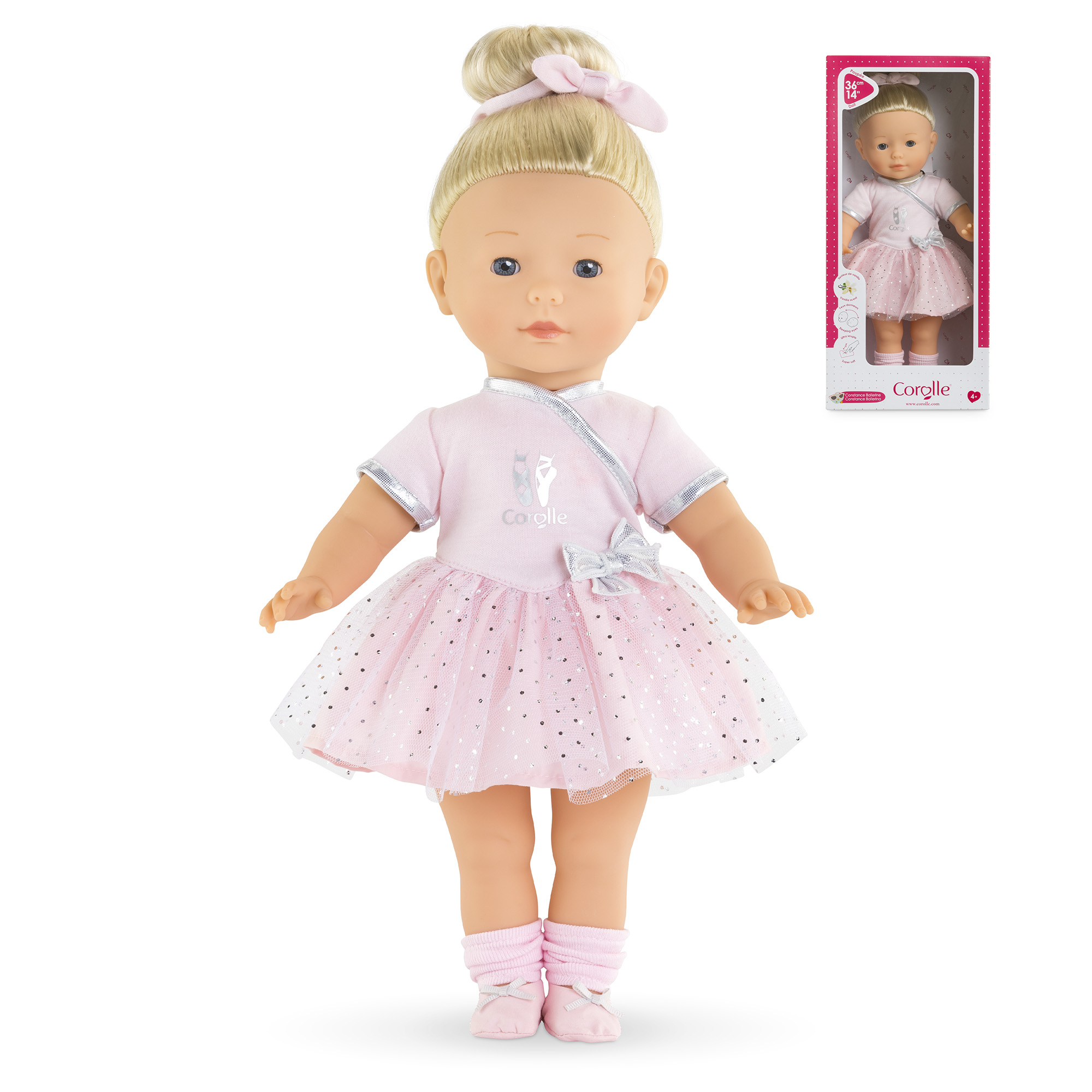 Eine Puppe in einem rosa Ballett-Outfit, mit blonden Haaren in einem Dutt. Eine Schachtel mit der Puppe befindet sich rechts.