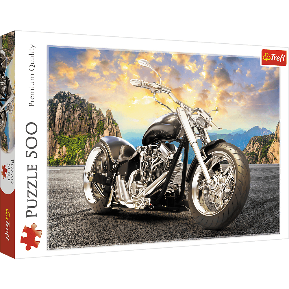 Un puzzle di moto. La moto è nera e cromata, sullo sfondo di montagne e cielo al tramonto.