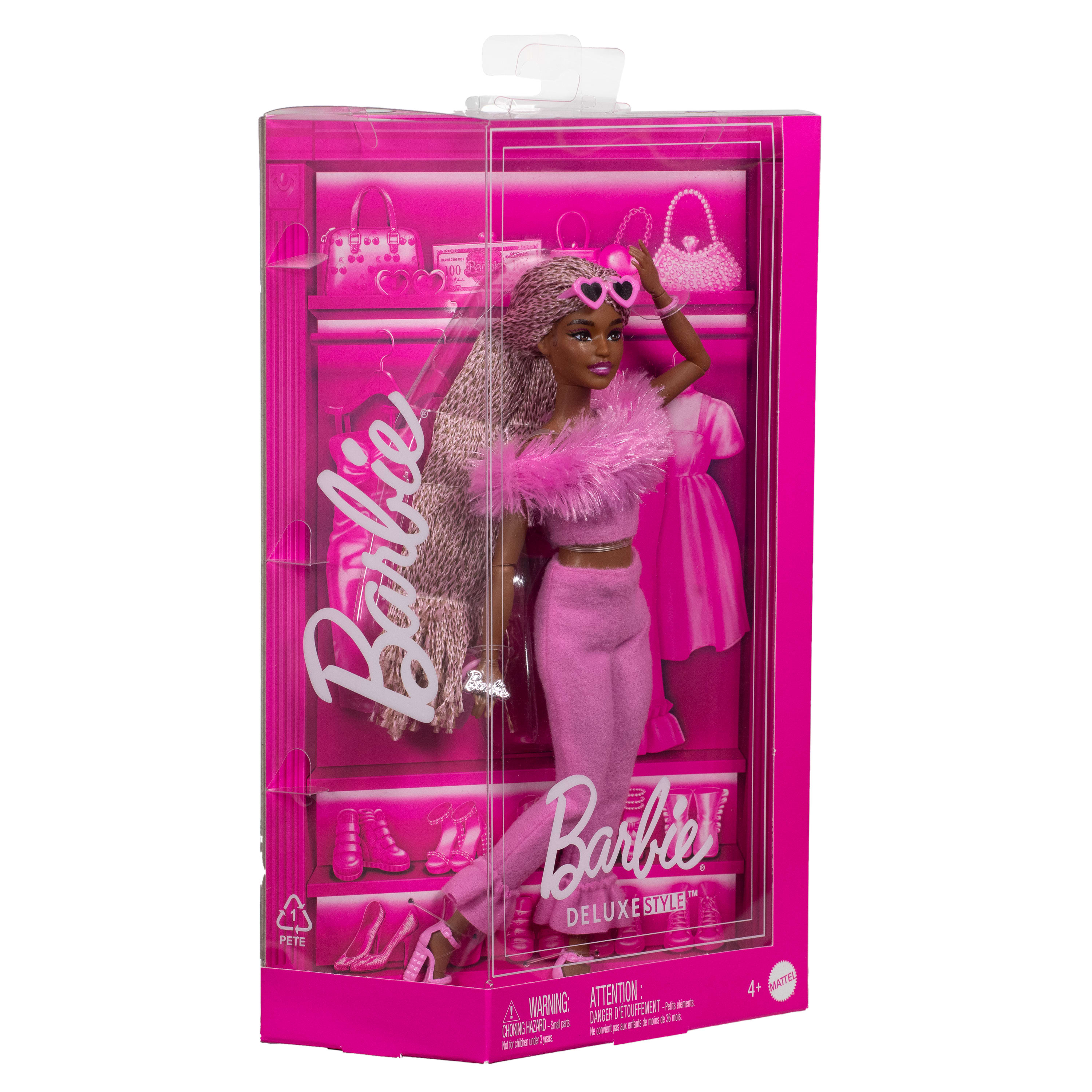 Barbie-Puppe in rosa Outfit, in einer rosa Display-Box. Die Puppe trägt herzförmige Sonnenbrille und hat lange Haare.