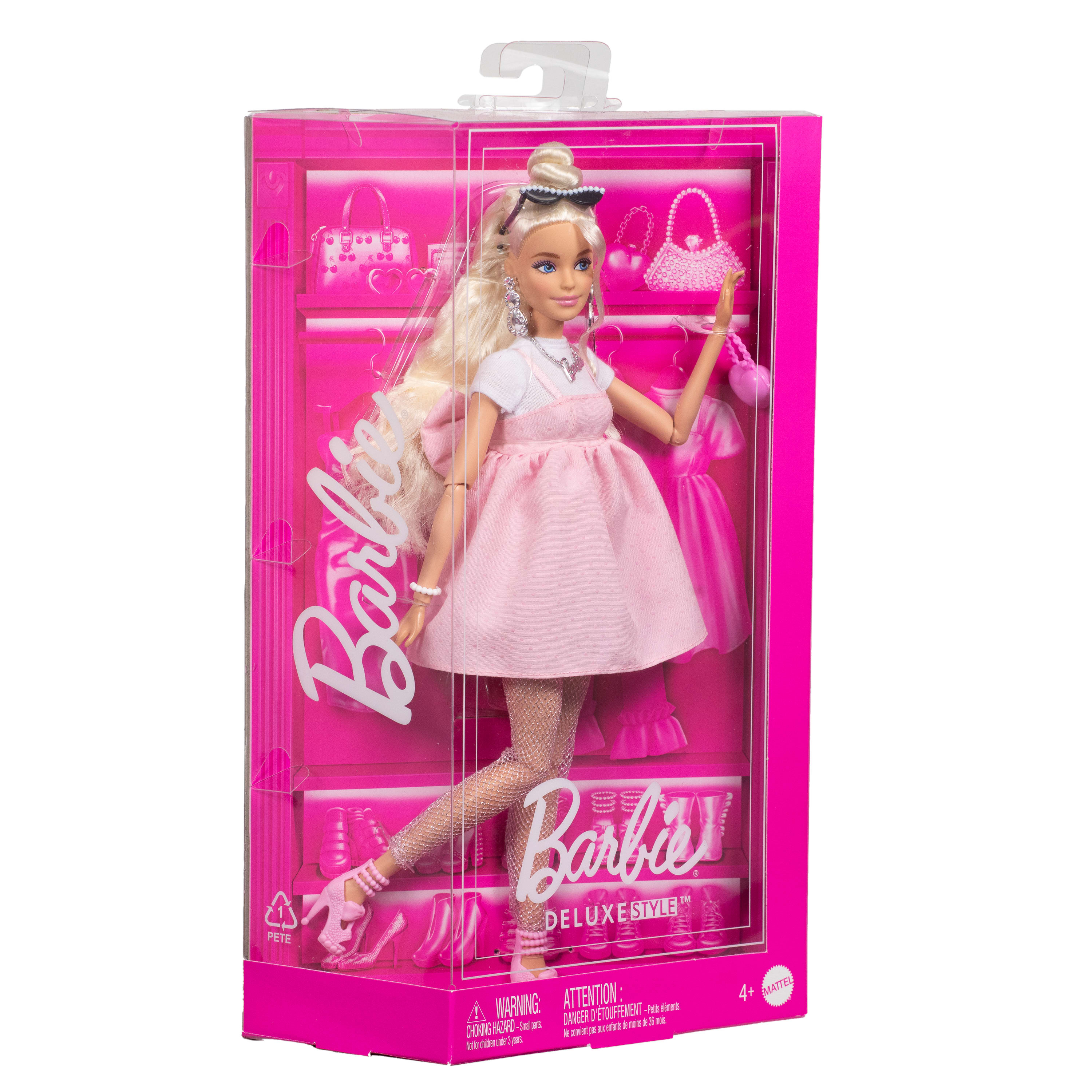 Eine Barbie-Puppe in einem rosa Kleid befindet sich in einer rosa Box. Auf der Box steht 'Barbie' und 'Deluxe Style'.