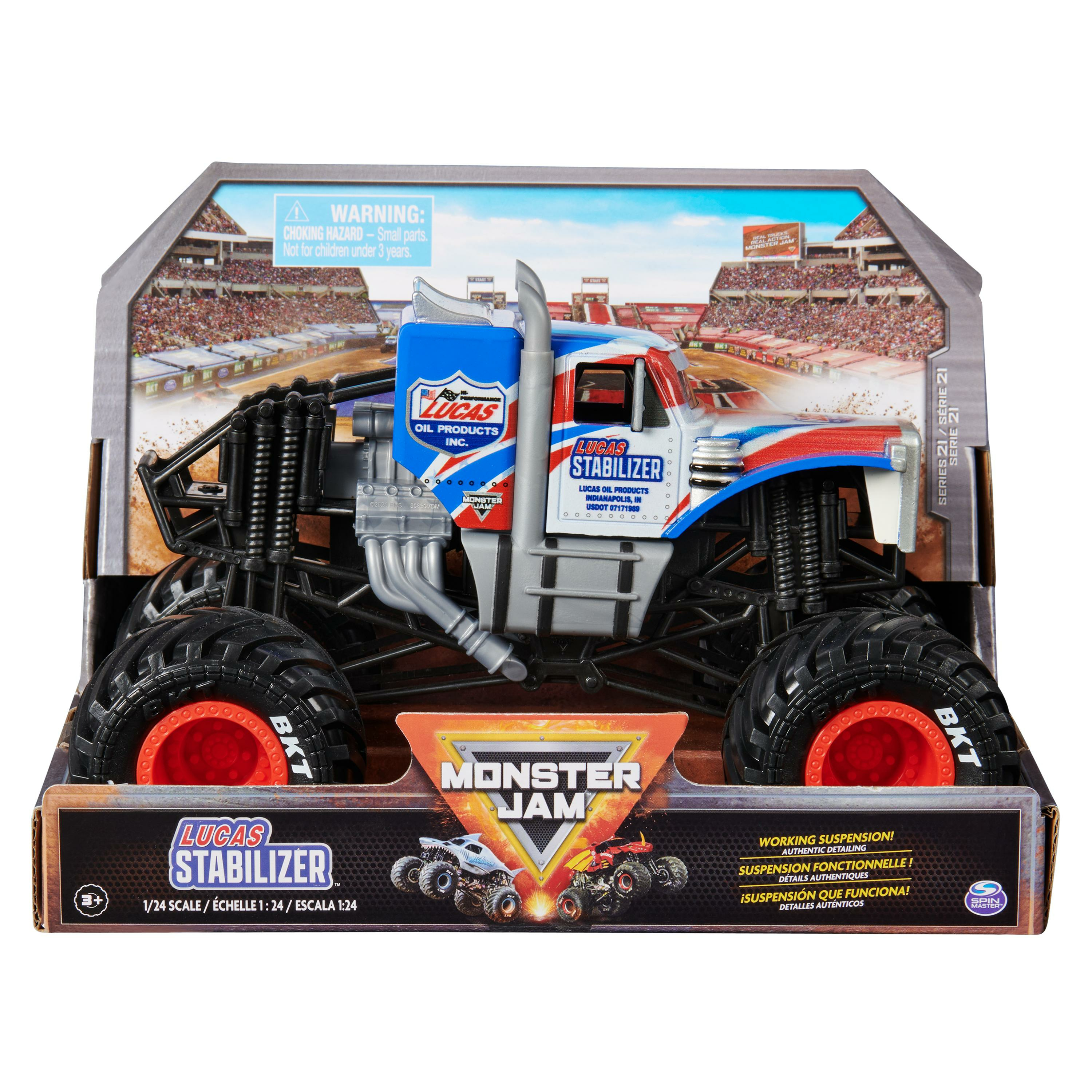 Camión Monster Jam en embalaje. Es rojo, blanco y azul, con ruedas negras grandes y detalles naranjas.