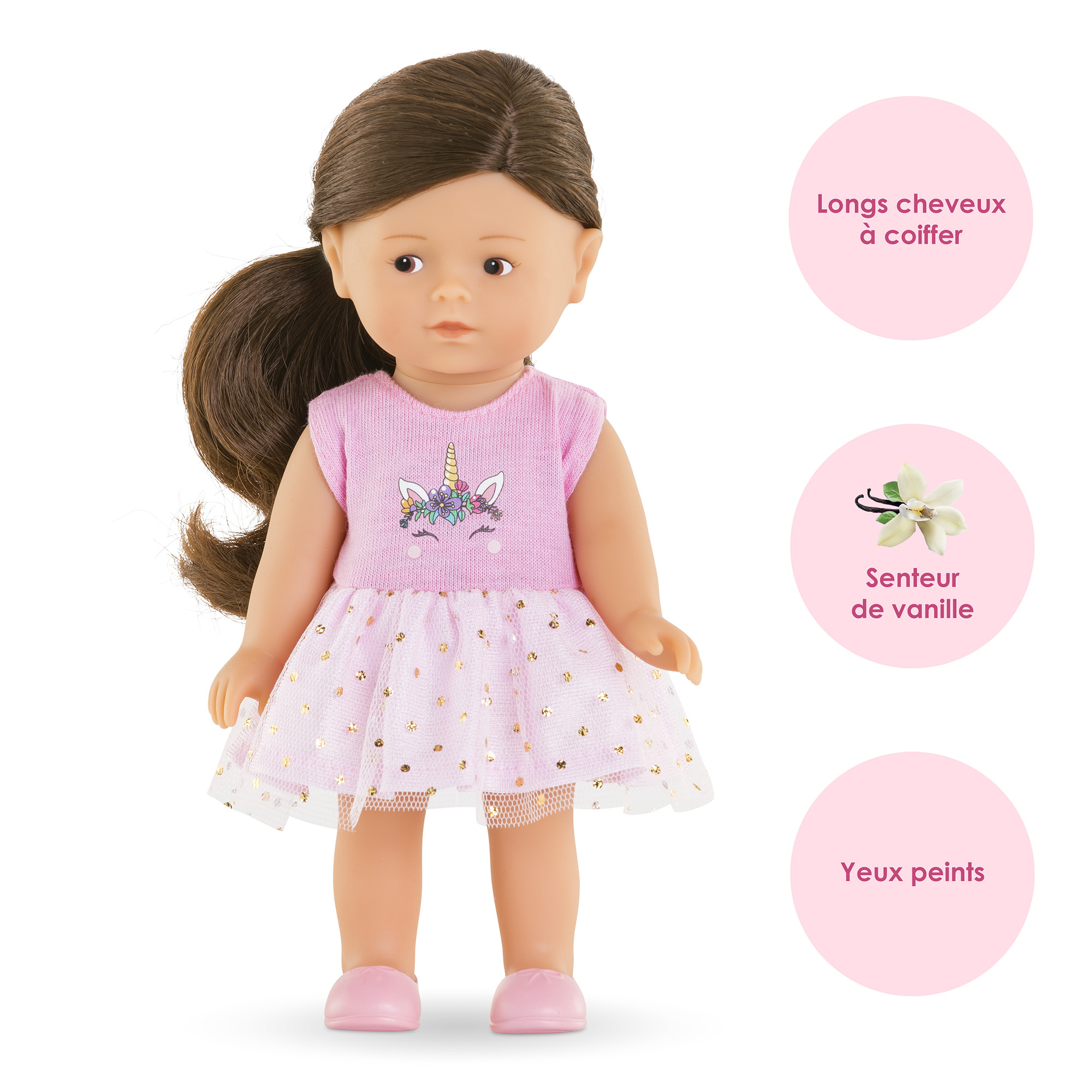 Eine Puppe mit braunen Haaren und einem rosa Kleid mit Einhorn-Design. Die Puppe hat bemalte Augen und rosa Schuhe.