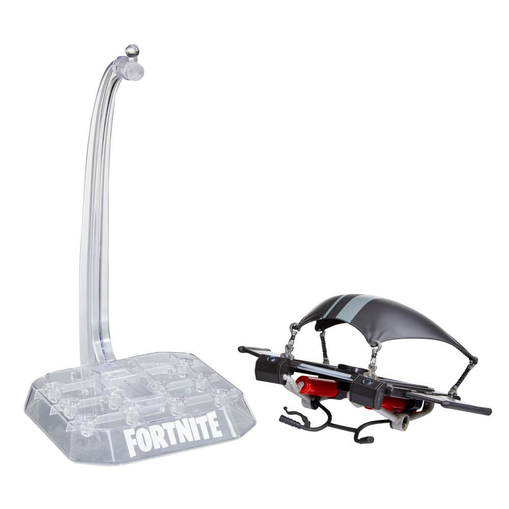 Un set di giocattoli di Fortnite. Include un supporto trasparente, un aliante nero e grigio e una base con il logo Fortnite.