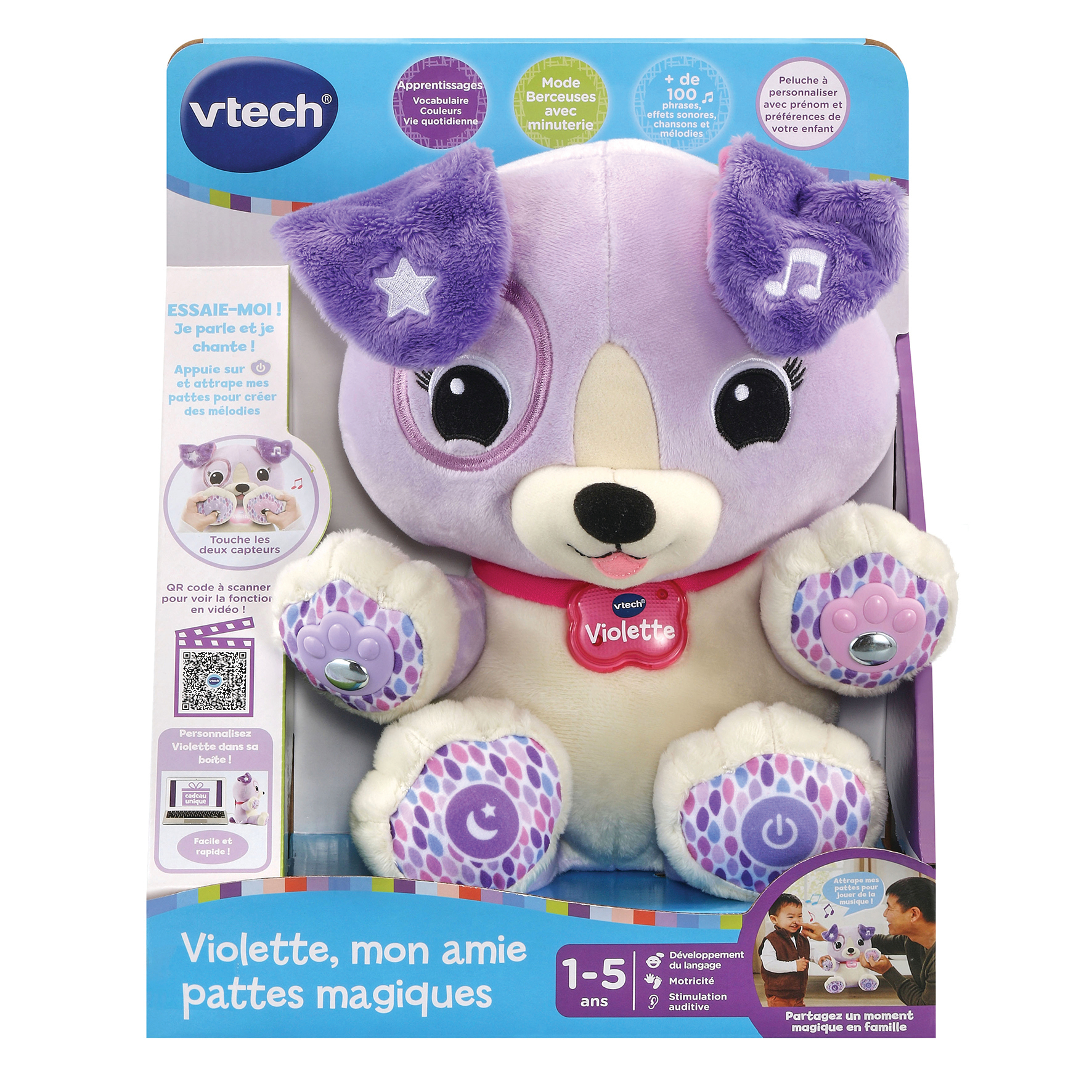 Un chien jouet VTech Violette violet et blanc dans une boîte. Il a des notes de musique, des étoiles et des empreintes.
