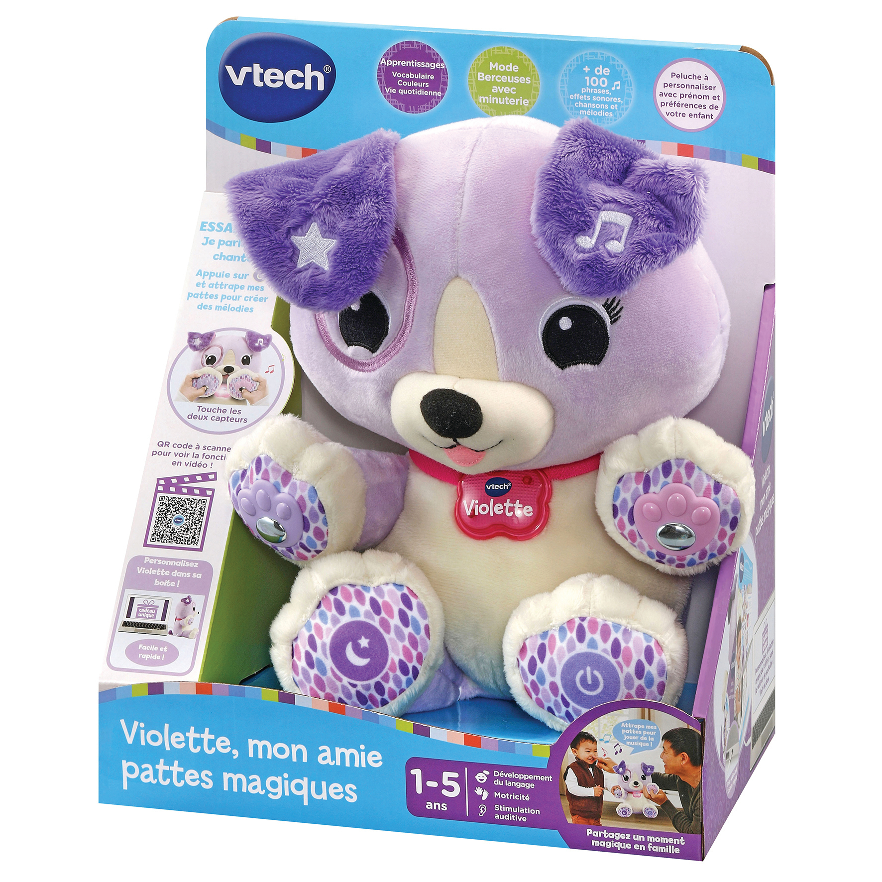 Une peluche chien violette nommée Violette, dans une boîte. Elle possède diverses fonctions interactives et est pour les enfants de 1 à 5 ans.