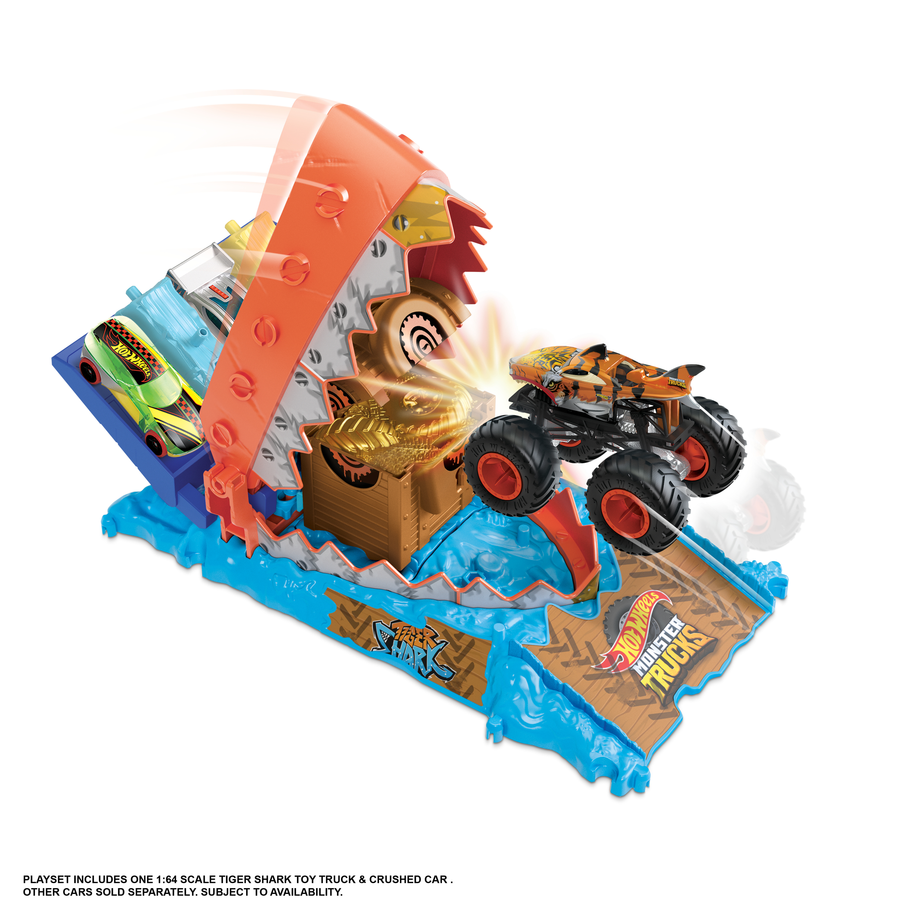 Zestaw Hot Wheels z monster truckiem, torem o tematyce rekina i samochodami. Ciężarówka przeskakuje drewnianą rampę.