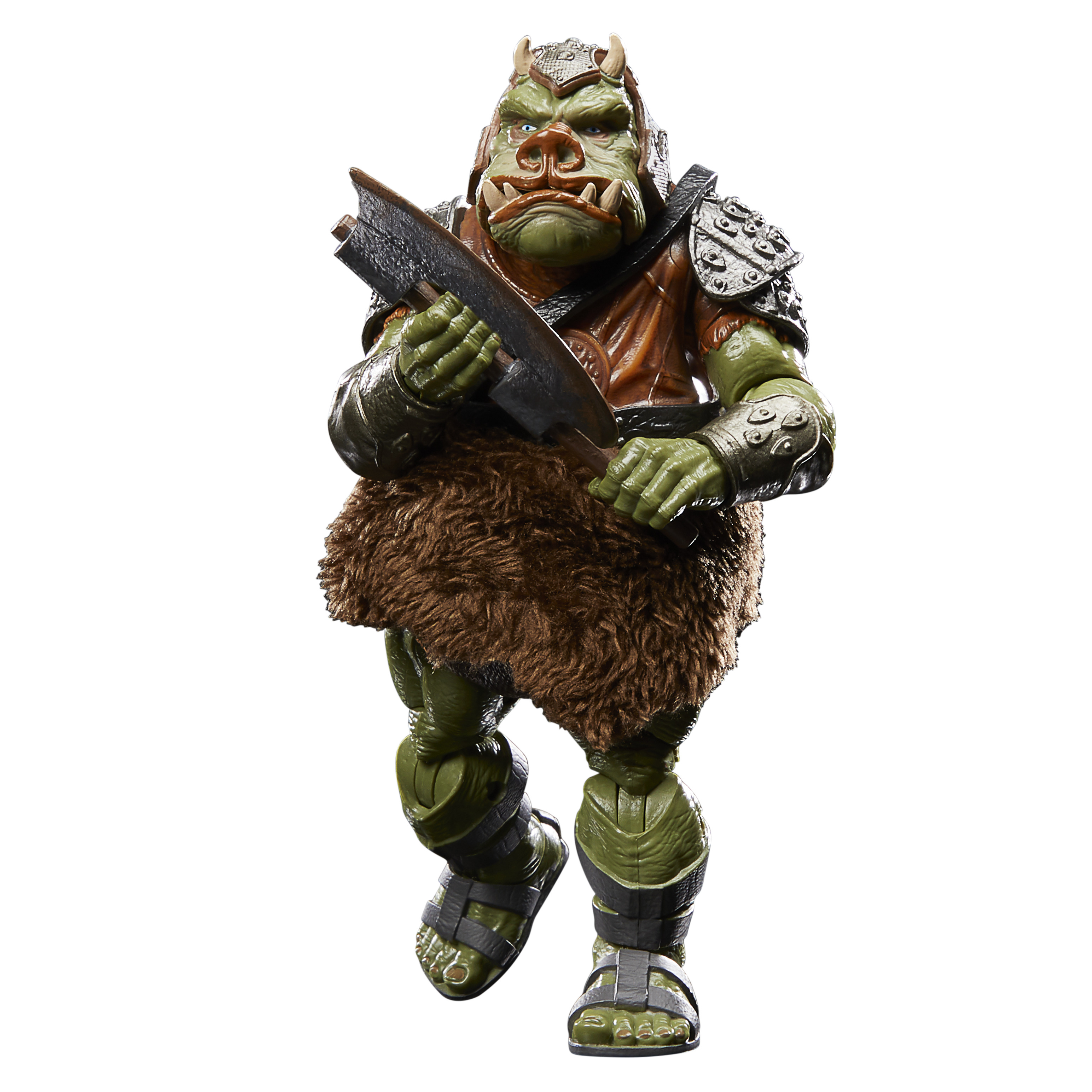 Una figura alienígena verde, con falda de piel marrón y armadura, sostiene un arma. Fondo blanco.