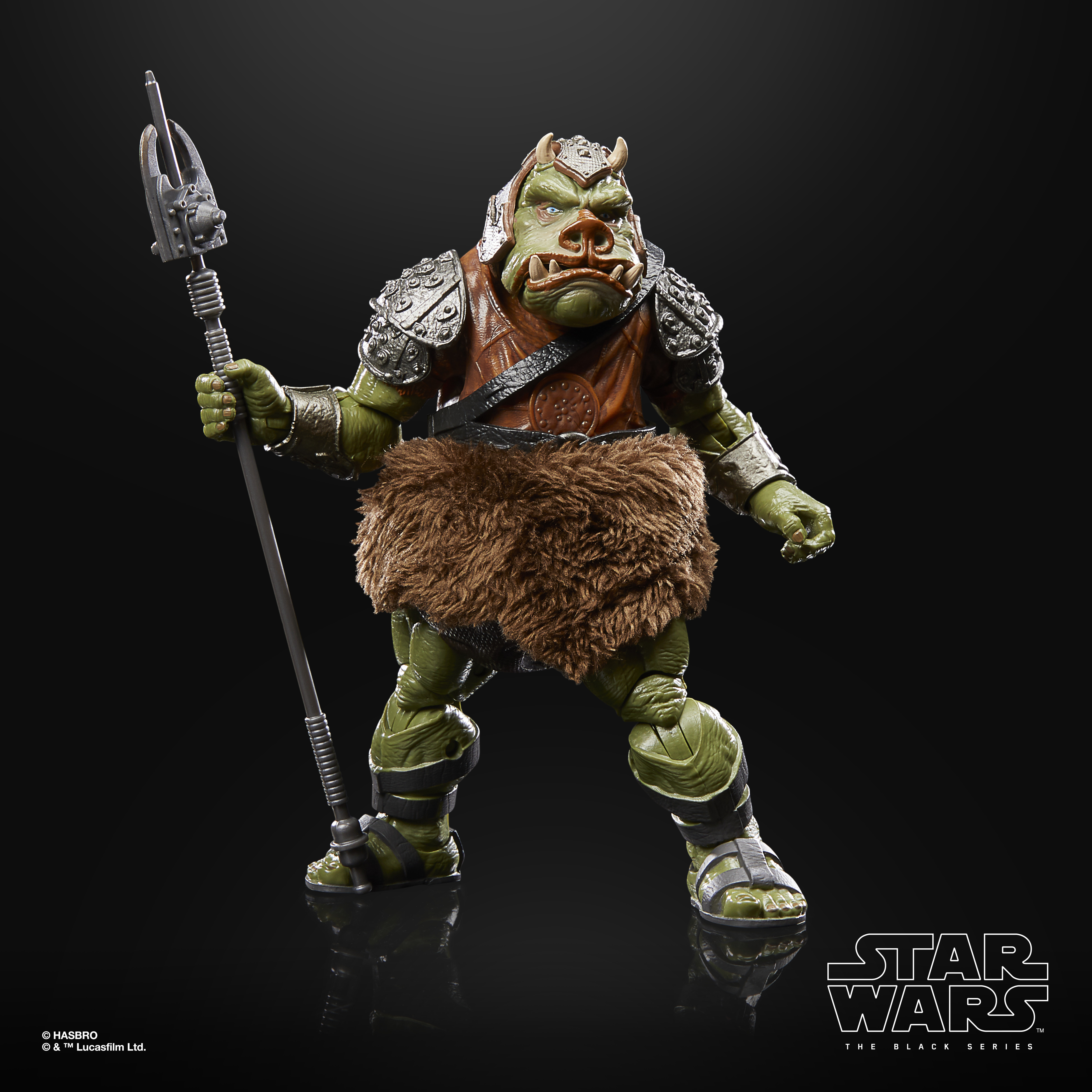 Una figura alienígena verde con una lanza. Lleva armadura y una falda peluda. Es una figura de Star Wars Black Series.
