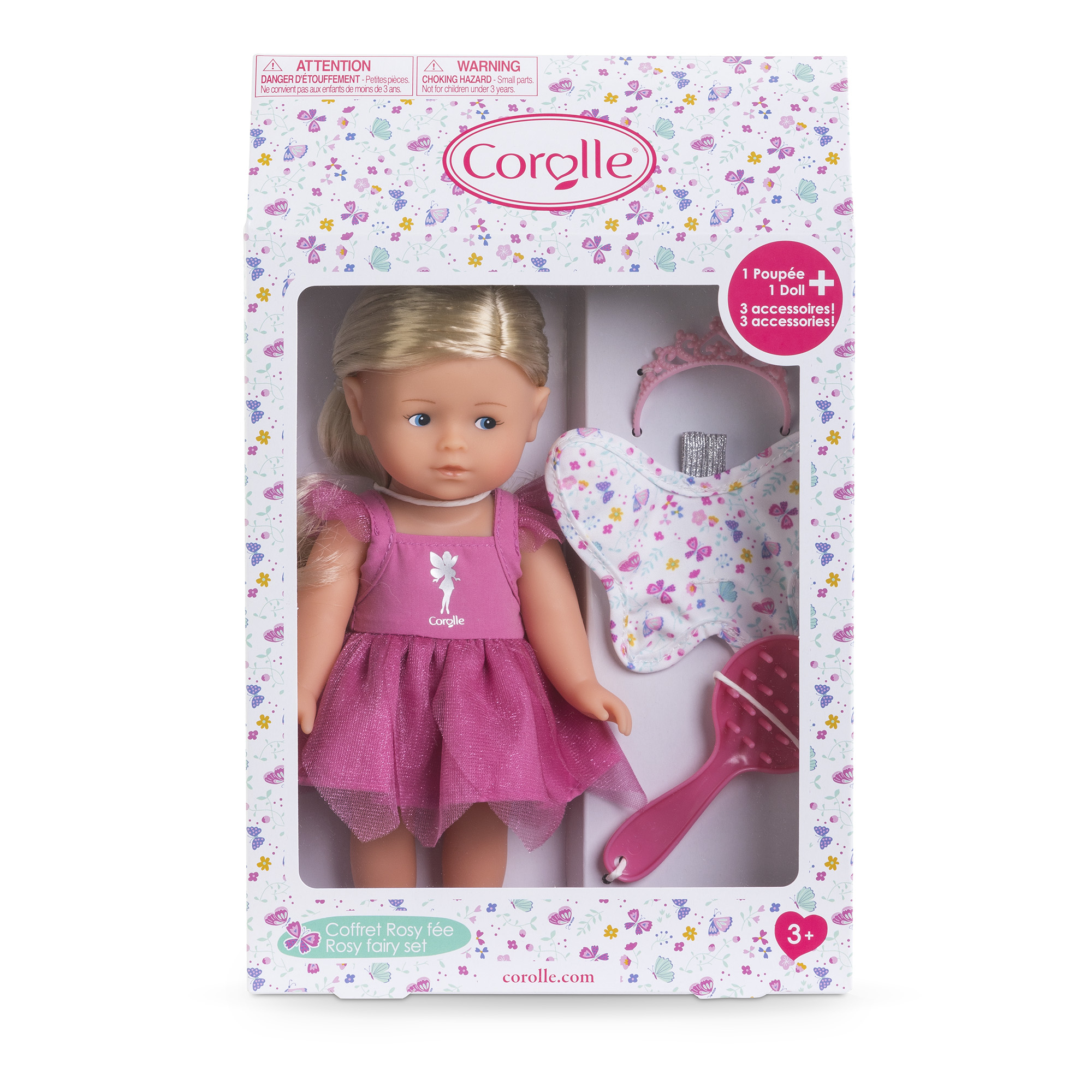 Eine Puppe in einer Schachtel mit rosa Kleid und Zubehör. Auf der Schachtel steht 'Rosy Fairy Set'. Ein Diadem und eine Bürste sind enthalten.
