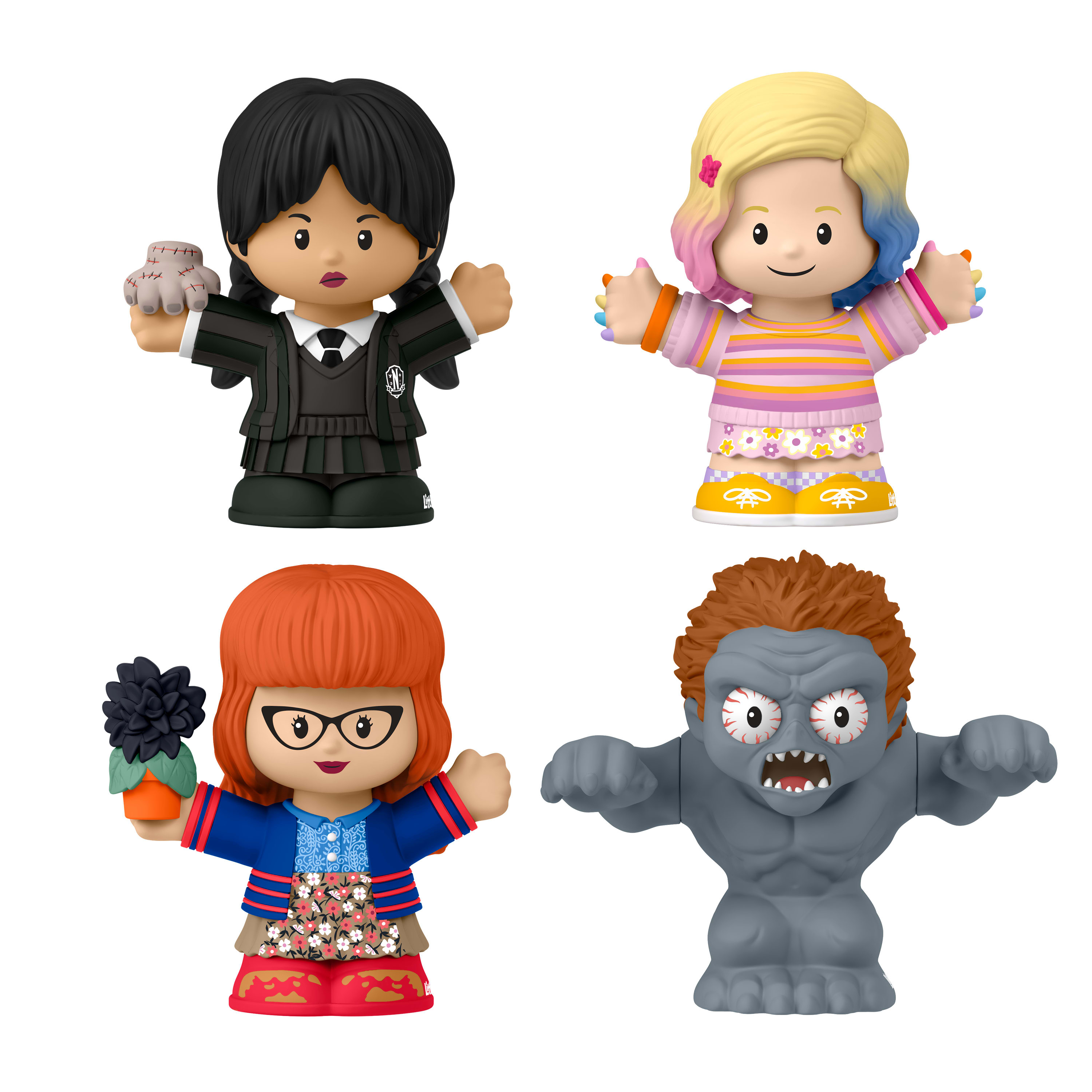 Vier bunte Little People Figuren. Wednesday Addams, Enid Sinclair, ein Mädchen mit Brille und eine zombieartige Figur.
