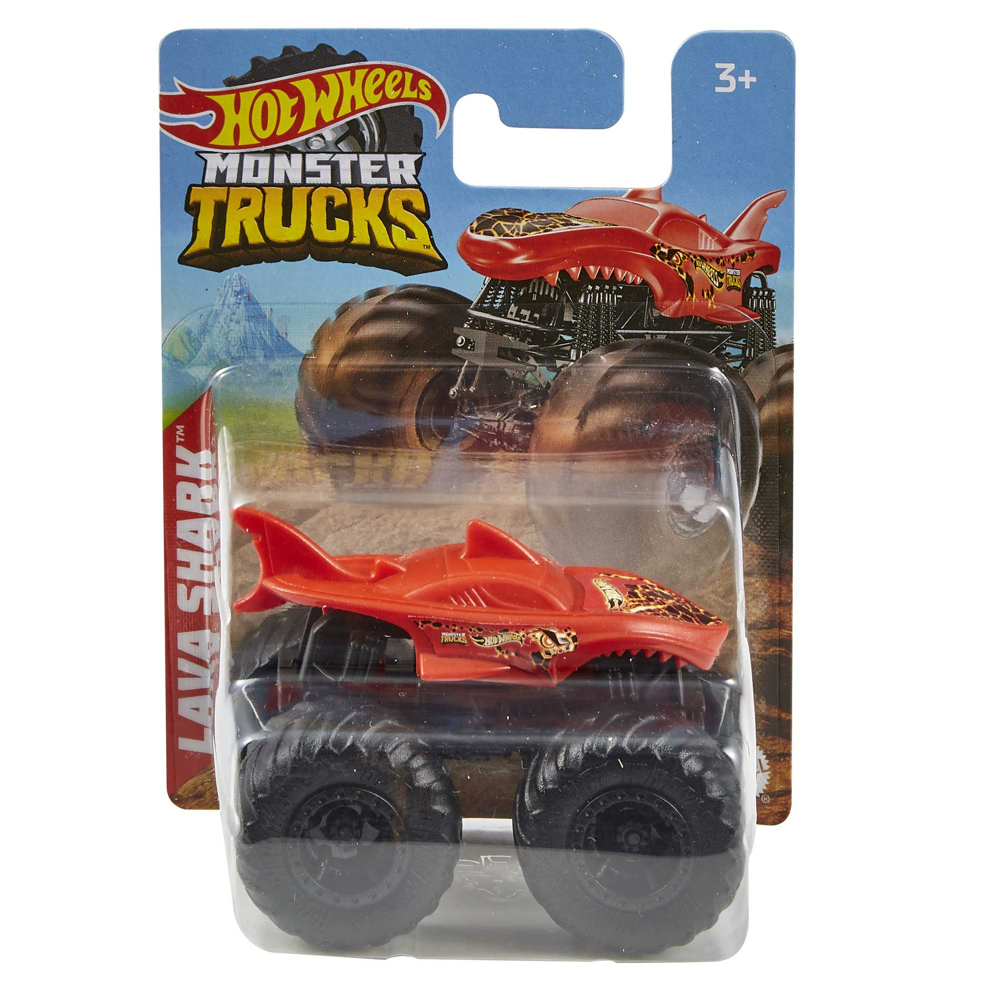 Hot Wheels Lava Shark monster truck w opakowaniu. Czerwony korpus w kształcie rekina, czarne koła, tło górskie.