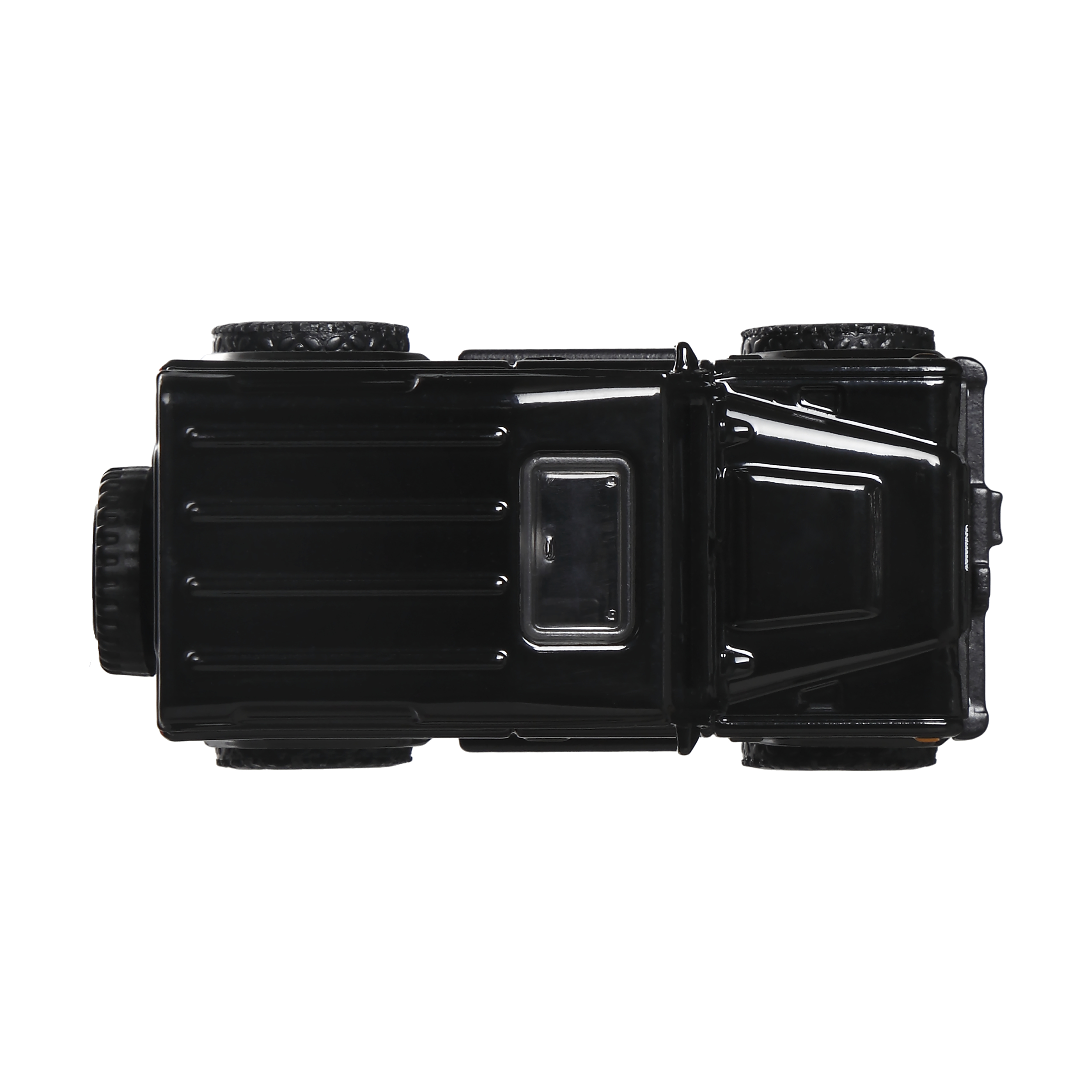 Widok z góry czarnej zabawki jeep na białym tle. Szczegóły obejmują opony, dach i okna.