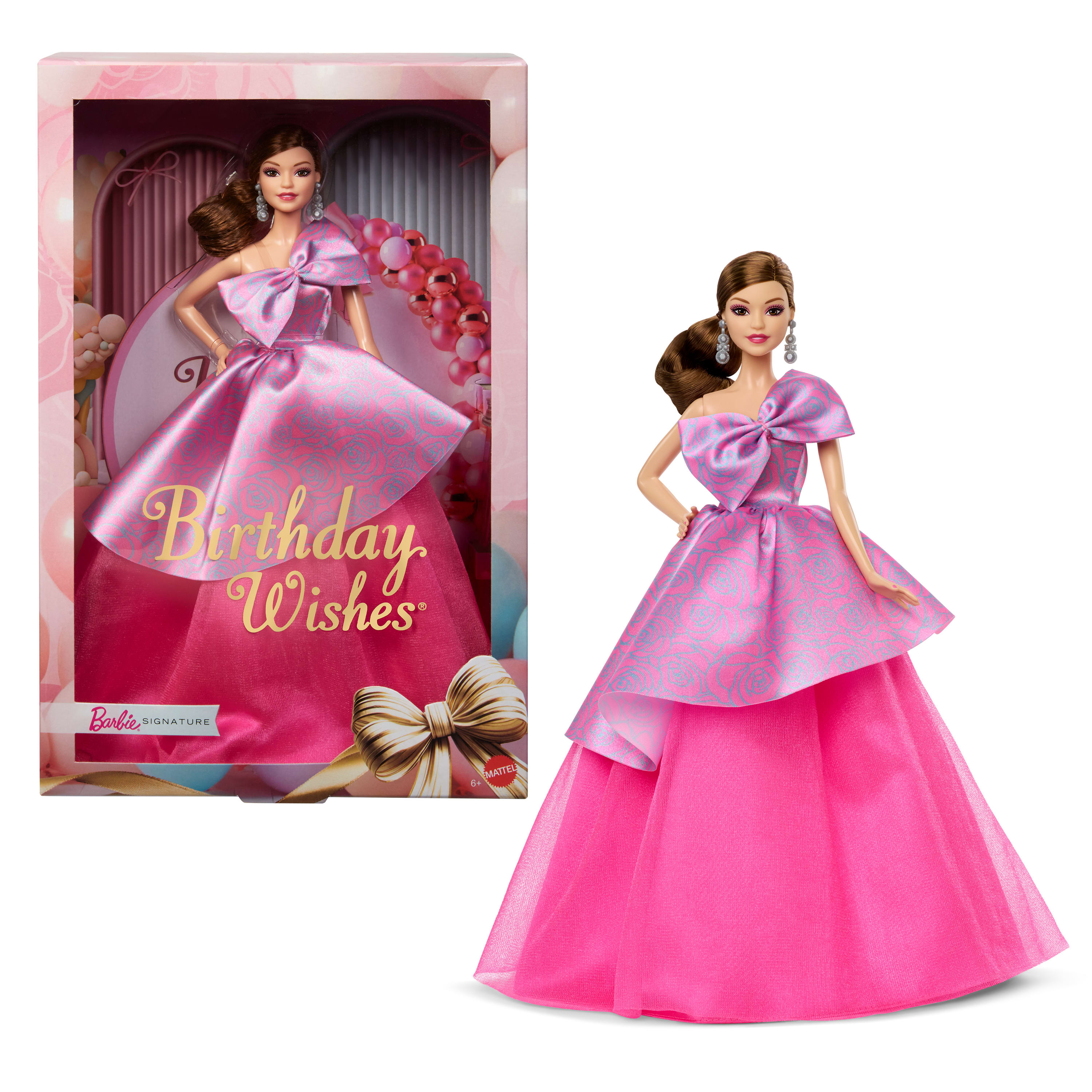 Barbie-Puppe in rosa Kleid mit Schleife. Verpackt mit Text 'Birthday Wishes'. Ein goldener Bogen ist sichtbar.