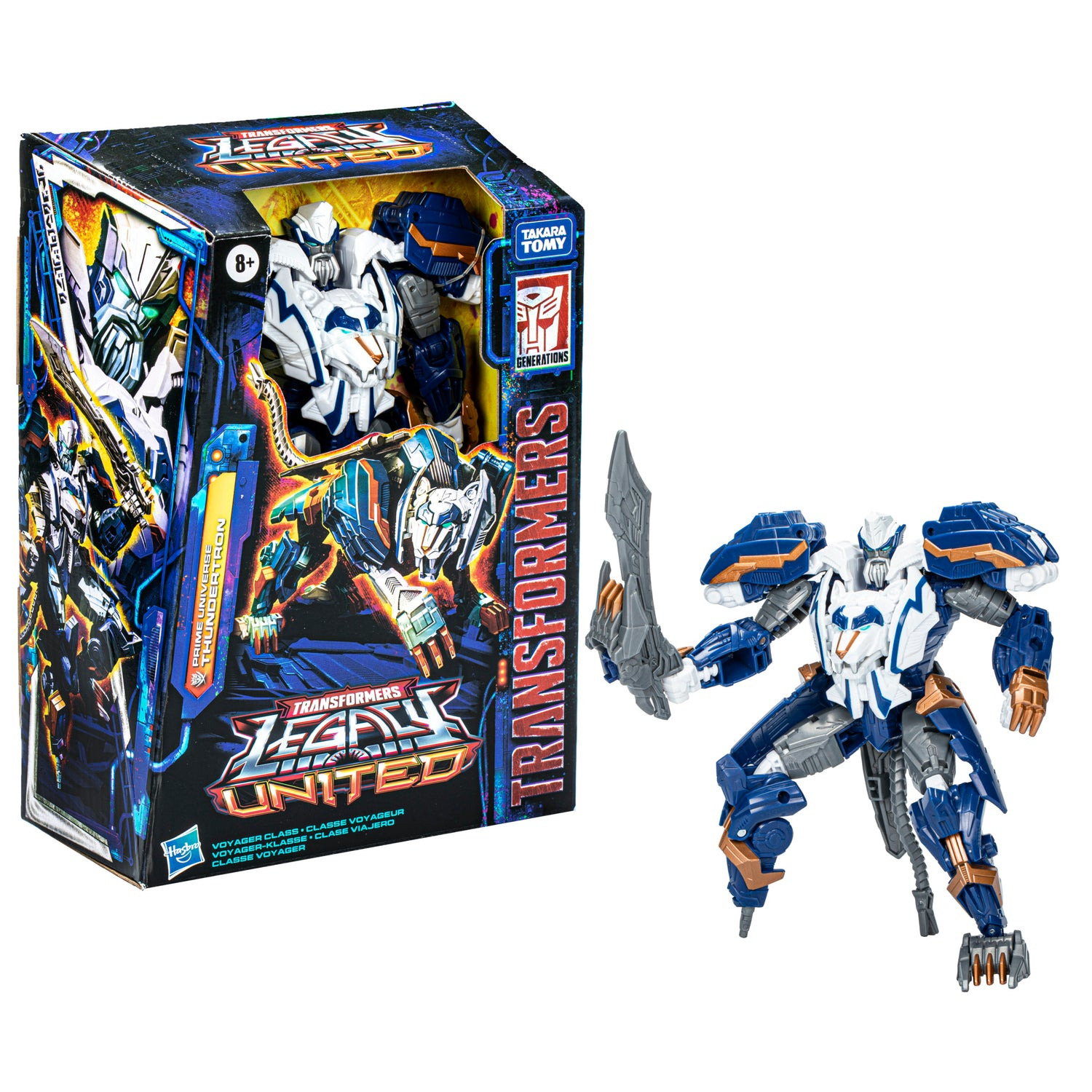 Un giocattolo Transformers, Thunderatron, nella sua scatola e in posa all'esterno. Il robot è bianco, blu e oro, con una spada. La scatola ha colori vivaci.