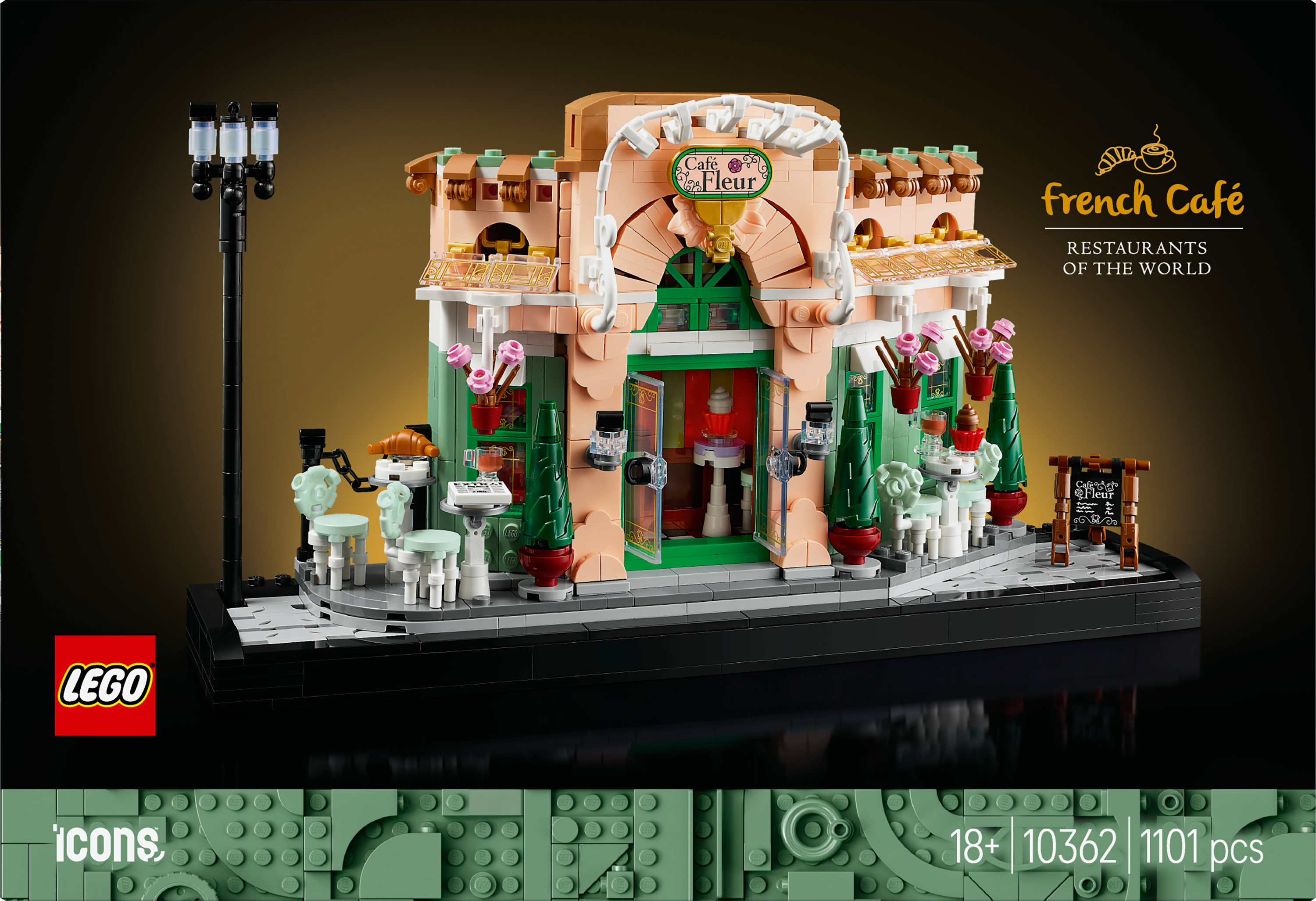 Set de Lego French Cafe. El edificio presenta una fachada rosa con detalles verdes, puertas abiertas y asientos al aire libre.