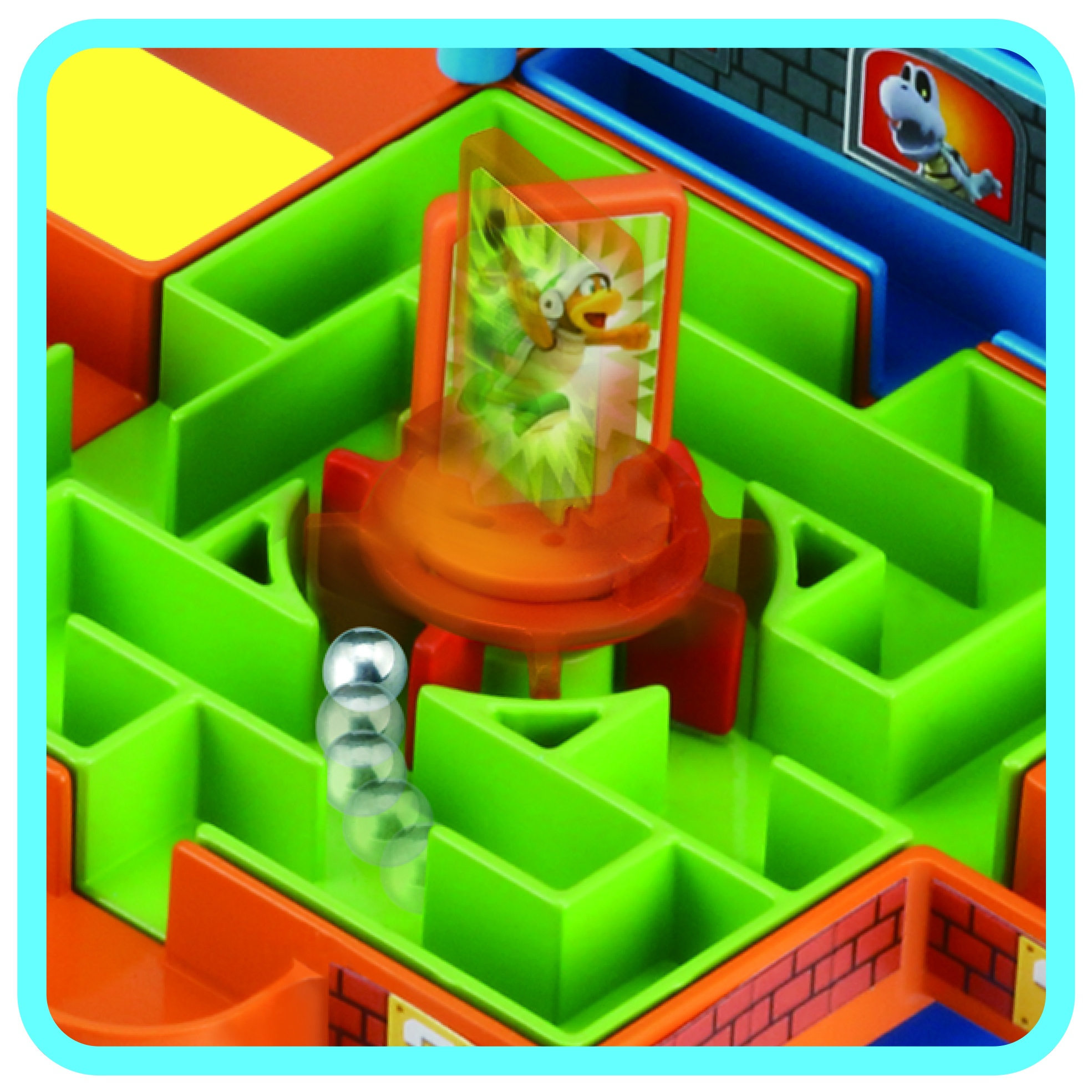 Kolorowa gra w labiryncie z wyświetlaczem postaci. Srebrne kulki poruszają się po zielonym labiryncie. Pomarańczowy wyświetlacz pokazuje postać.