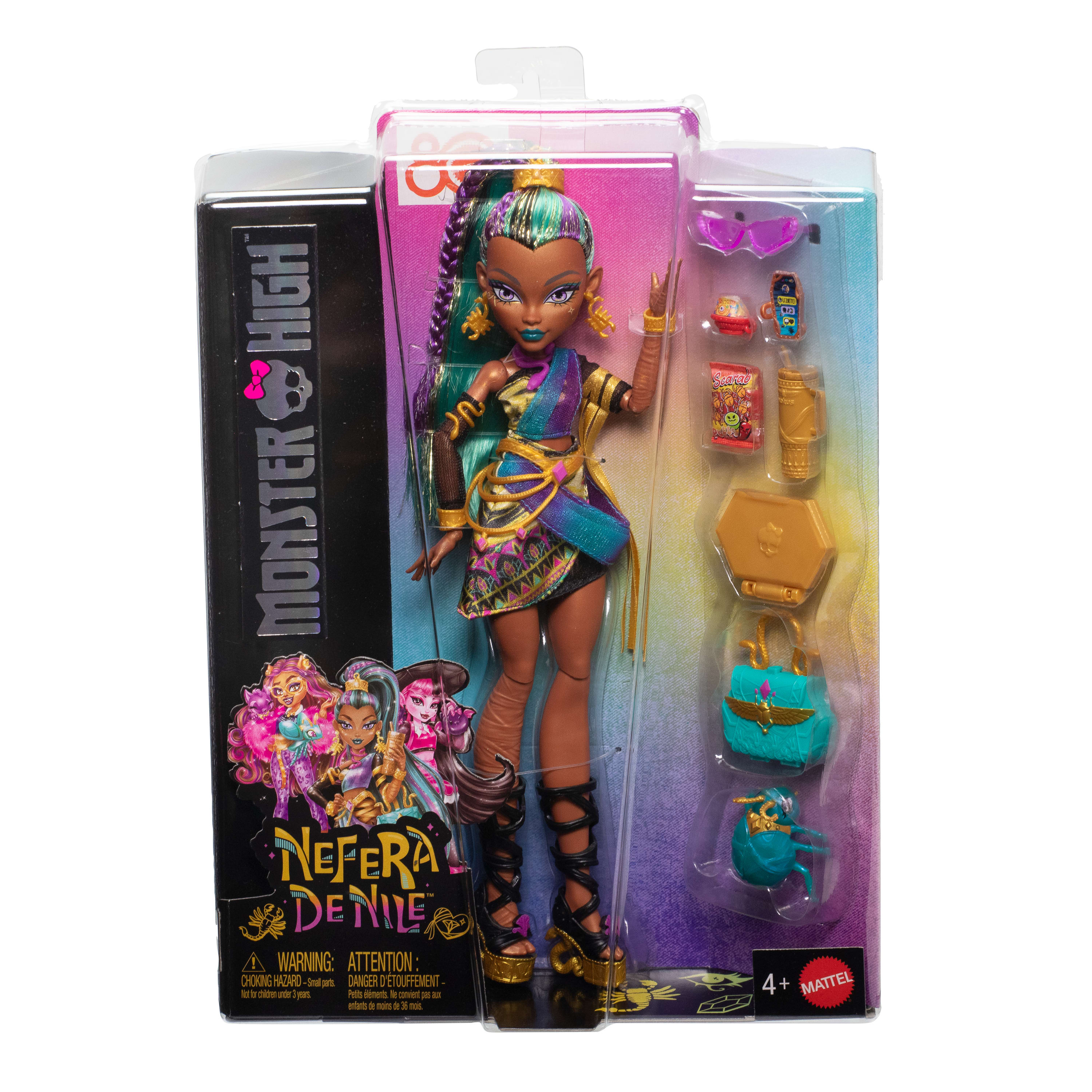 Una muñeca Monster High, Nefera de Nile, en un paquete. Tiene detalles en verde azulado, dorado y morado. Accesorios incluidos.