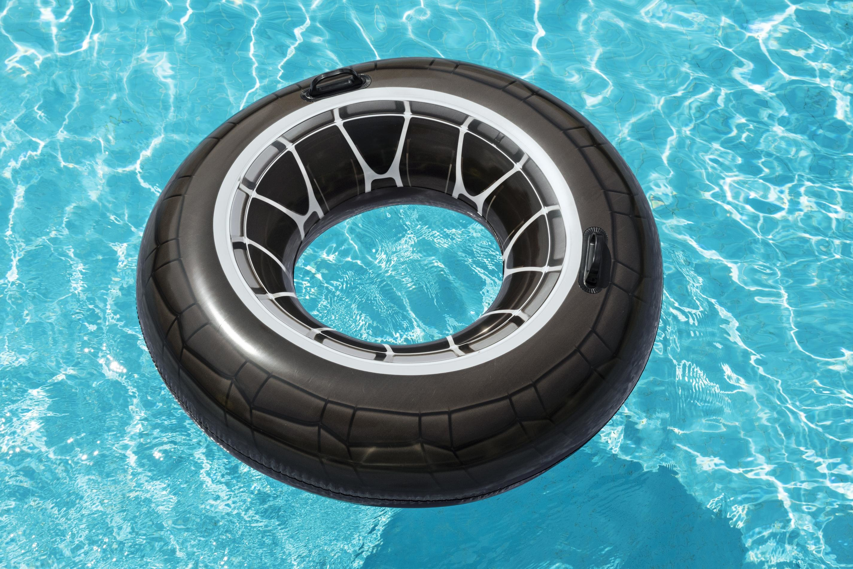 A black and white inflatable pool float in a pool of blue water.
