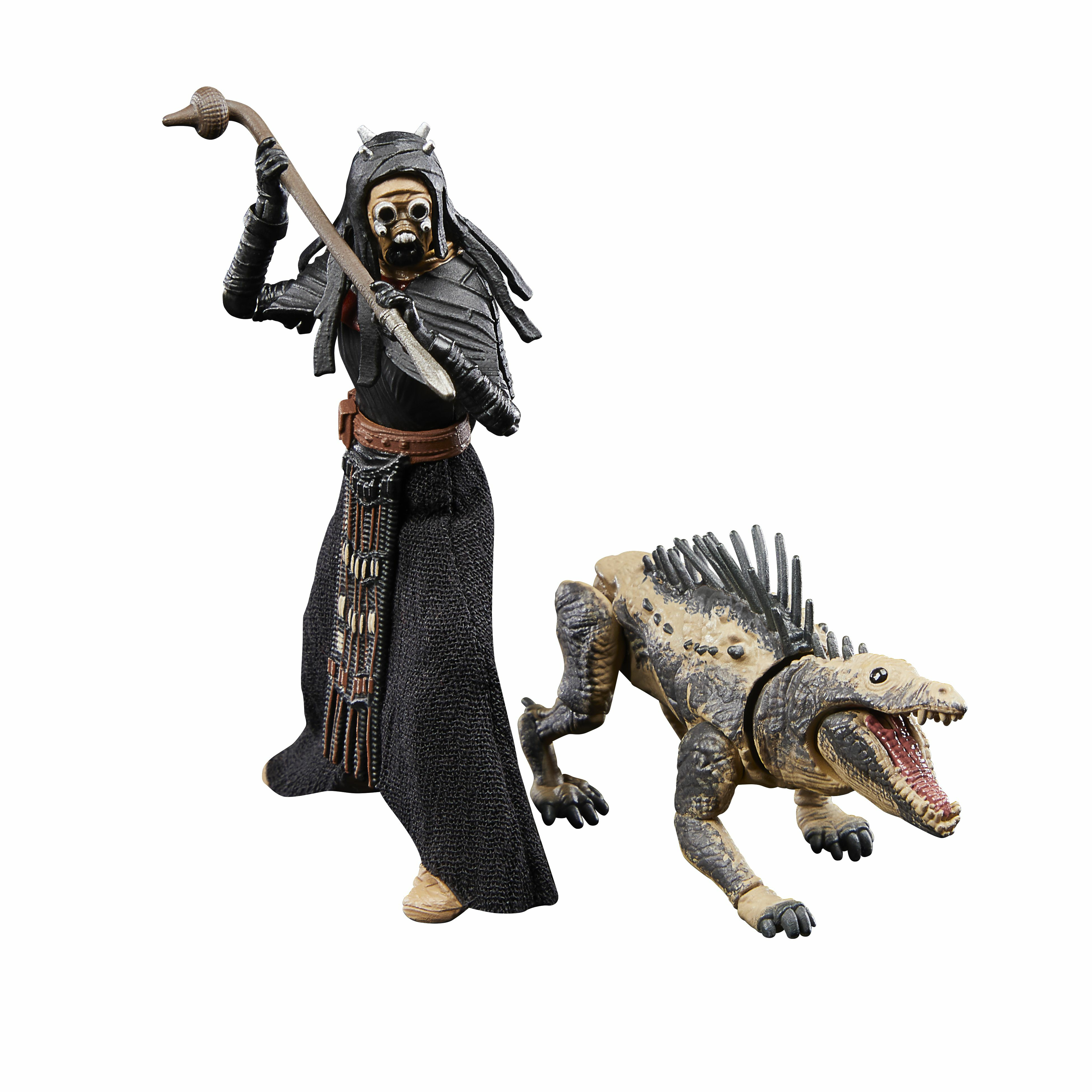 Una figura con túnicas negras y un bastón está junto a una criatura parecida a un lagarto con la boca abierta.