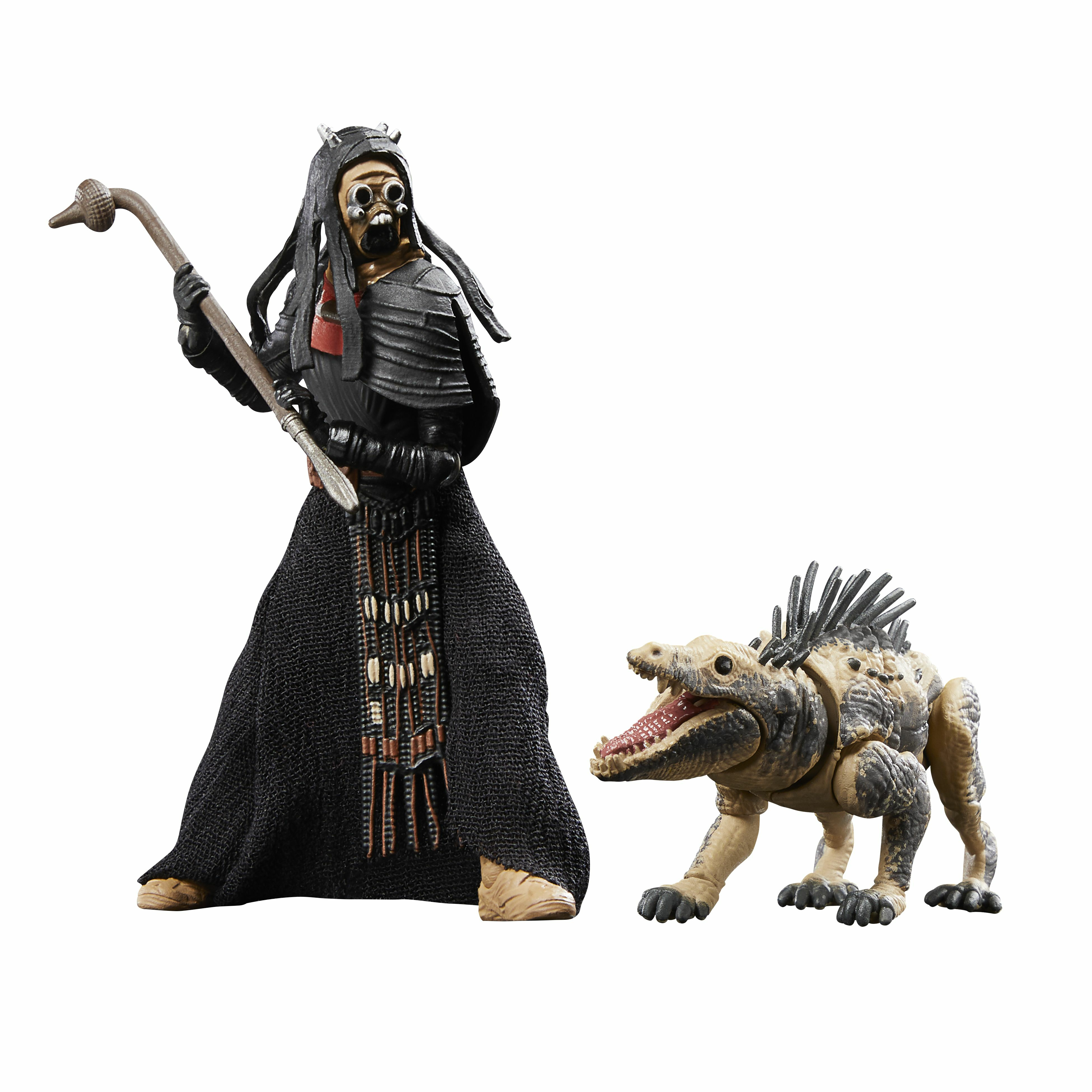 Una figura con armadura negra sostiene un bastón. A su lado, una criatura reptiliana con la boca abierta.