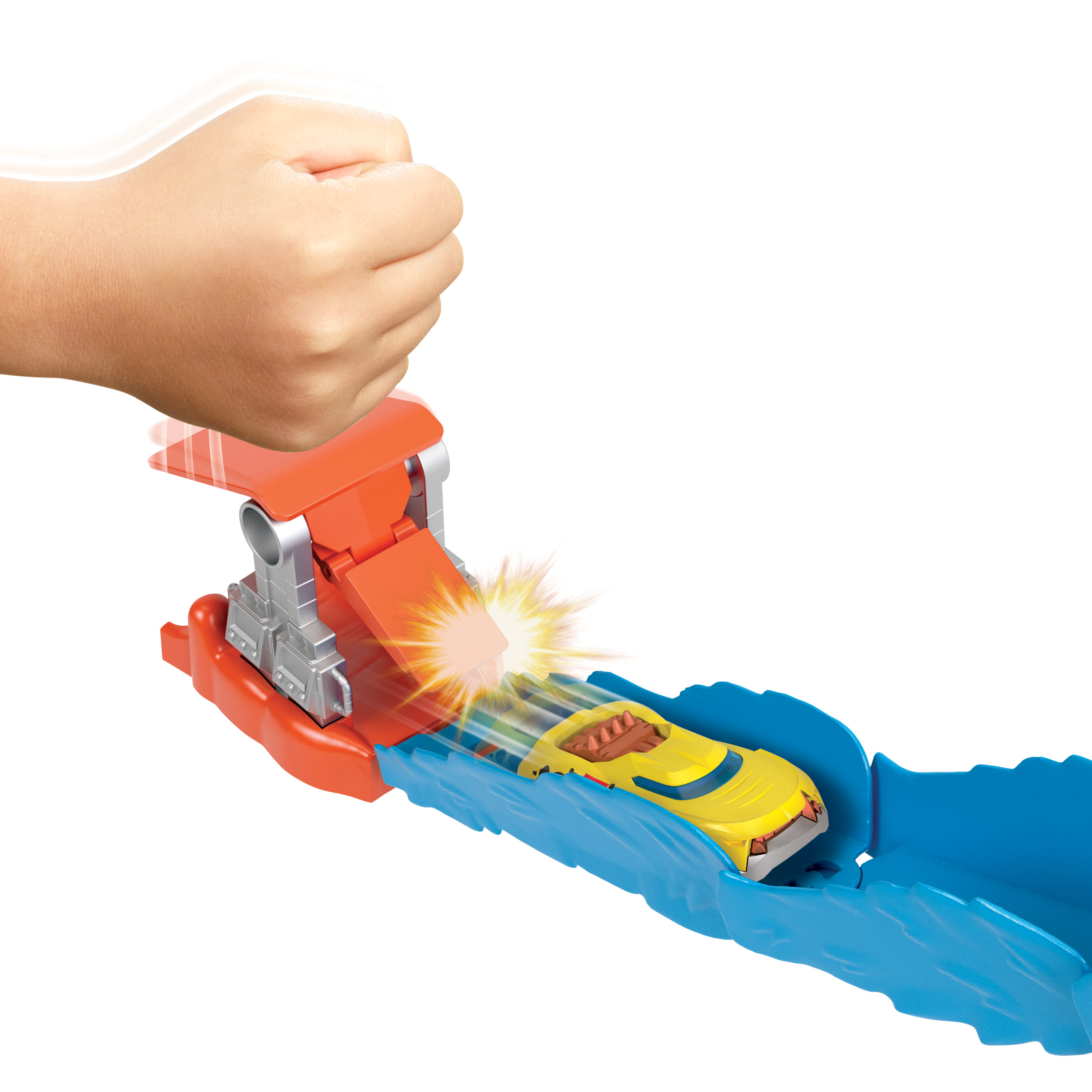 Ręka aktywuje tor samochodowy. Żółty samochód pędzi przez niebieski tor. Pomarańczowy mechanizm.