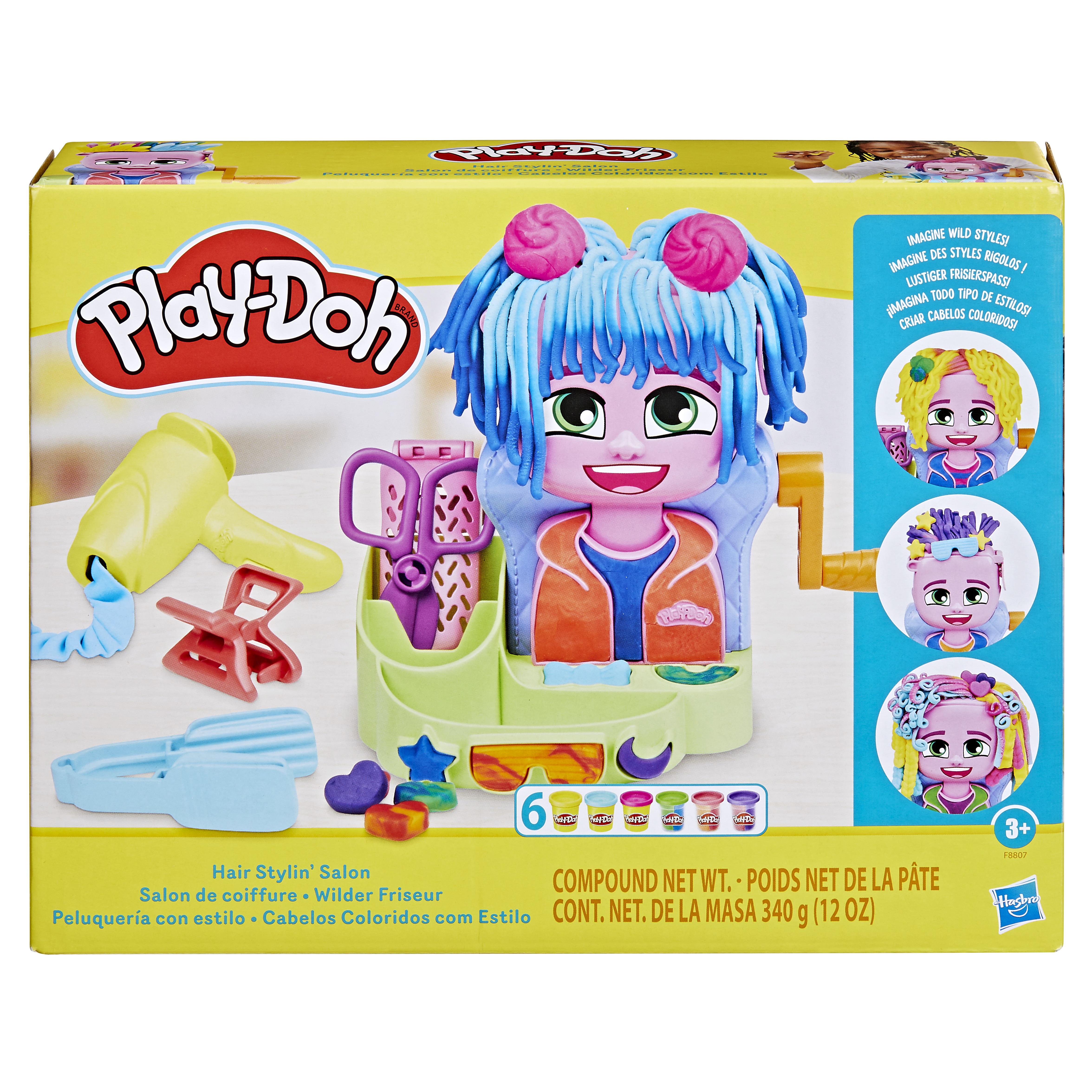 Caja de Play-Doh Hair Stylin' Salon. Presenta una muñeca, herramientas y Play-Doh. Incluye rosa, azul, amarillo y morado.