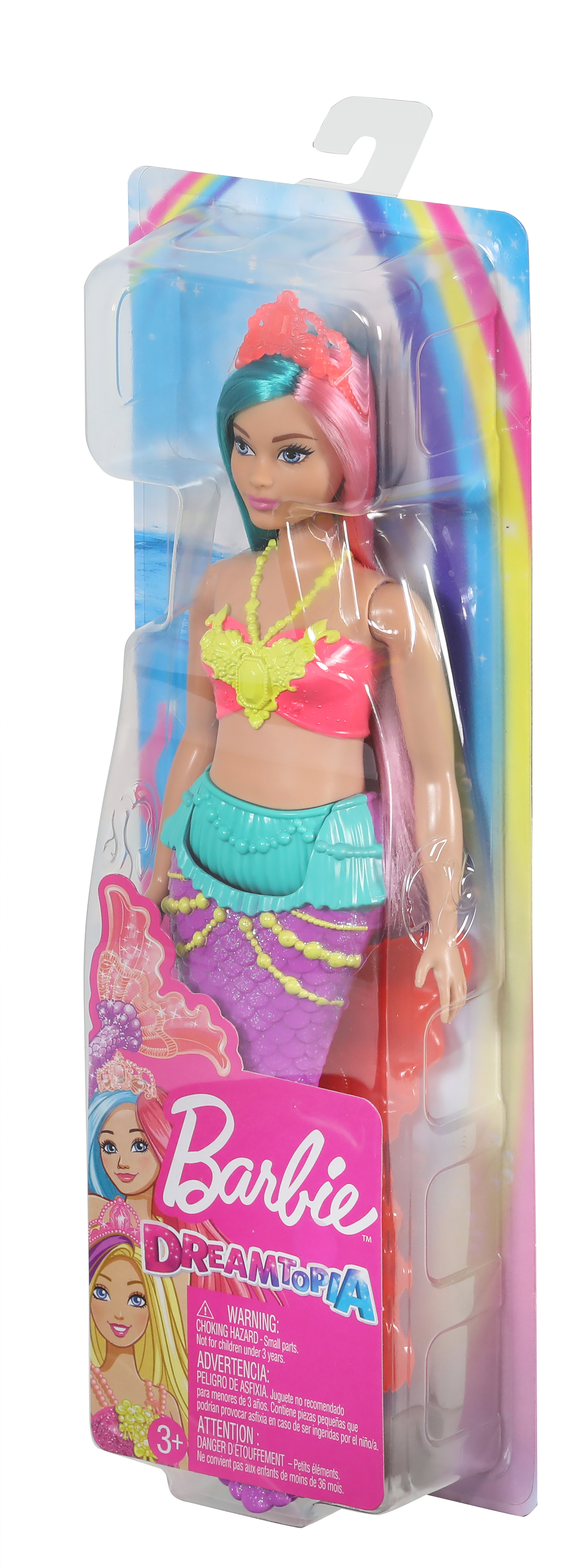 Une poupée sirène Barbie Dreamtopia dans son emballage. La poupée a des cheveux roses et sarcelle, un haut rose et une queue violette. Le fond est un arc-en-ciel.