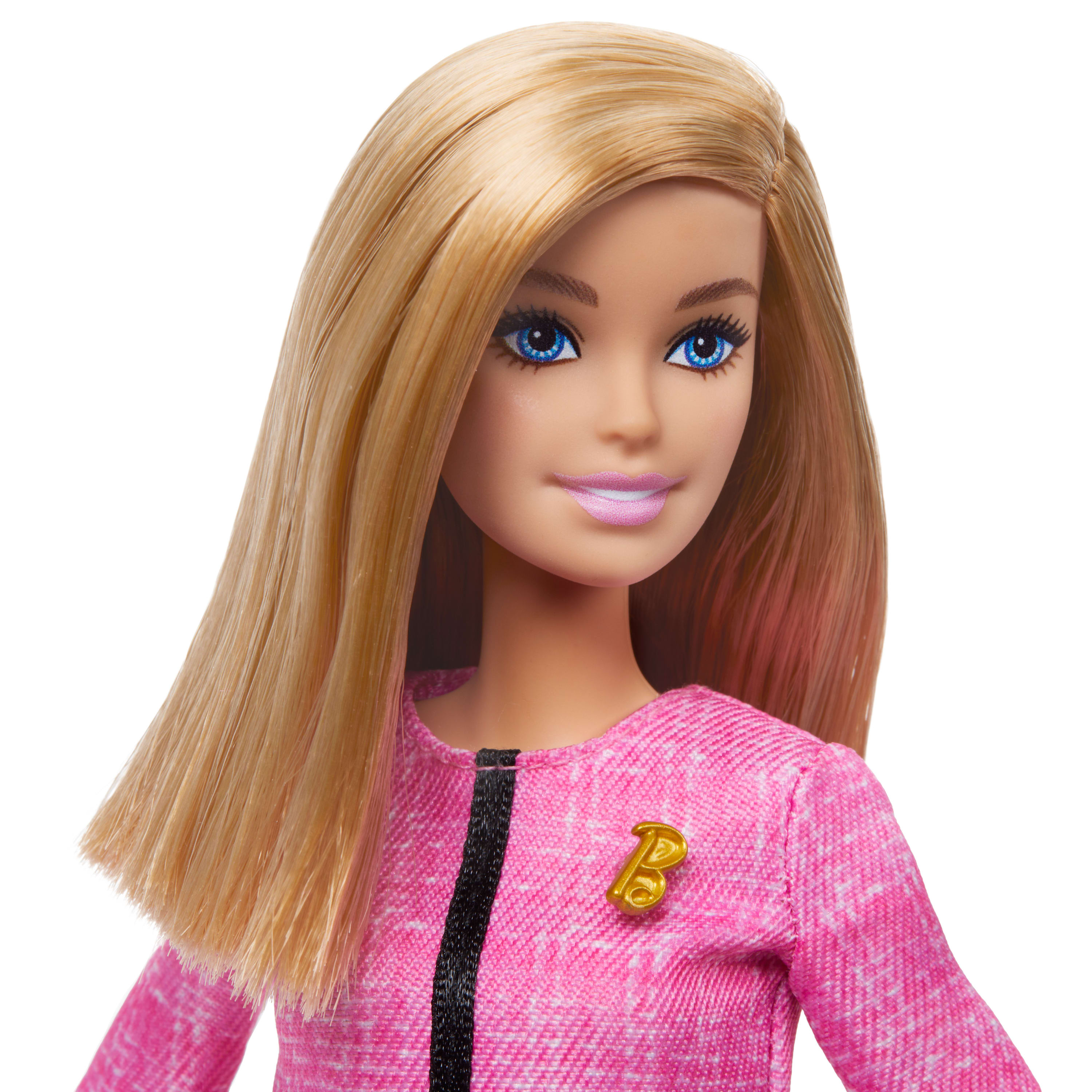 Barbie-Puppe mit langem blondem Haar, blauen Augen, trägt eine rosa Jacke mit goldenem 'B'-Anstecker, auf weißem Grund.