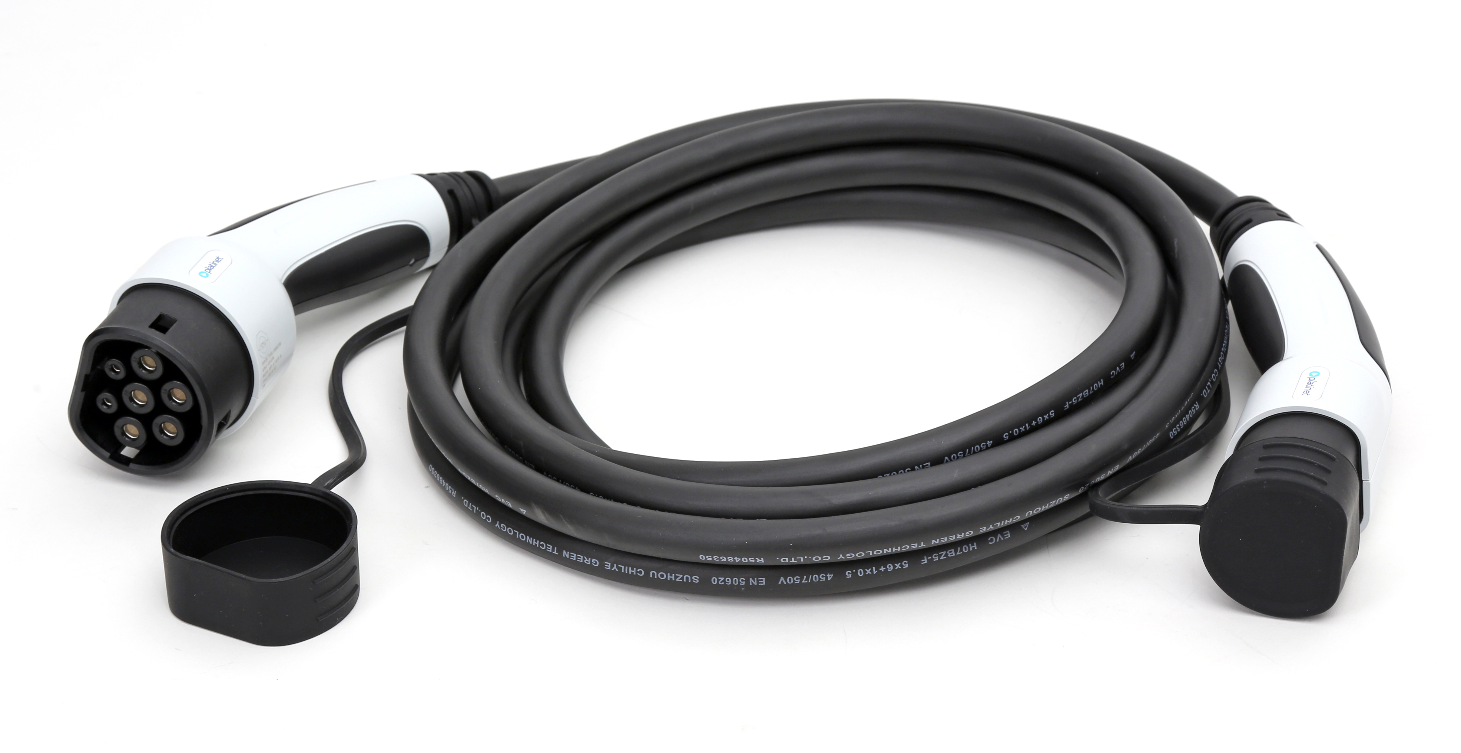 Un cavo di ricarica per veicoli elettrici con connettori bianchi e neri, cavo nero arrotolato su superficie bianca.