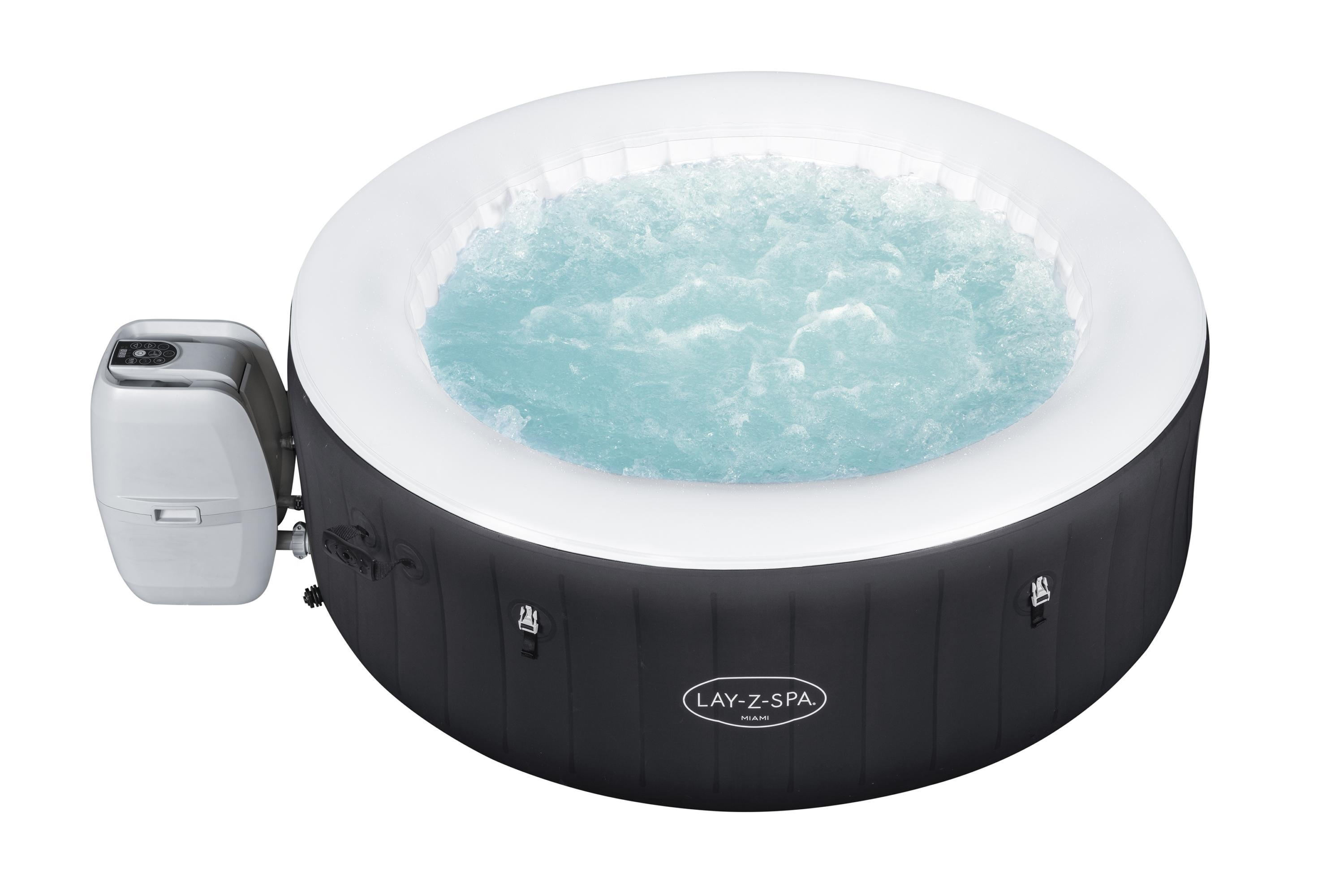 Una vasca idromassaggio gonfiabile con acqua frizzante. Nera con bordo bianco e pannello comandi.