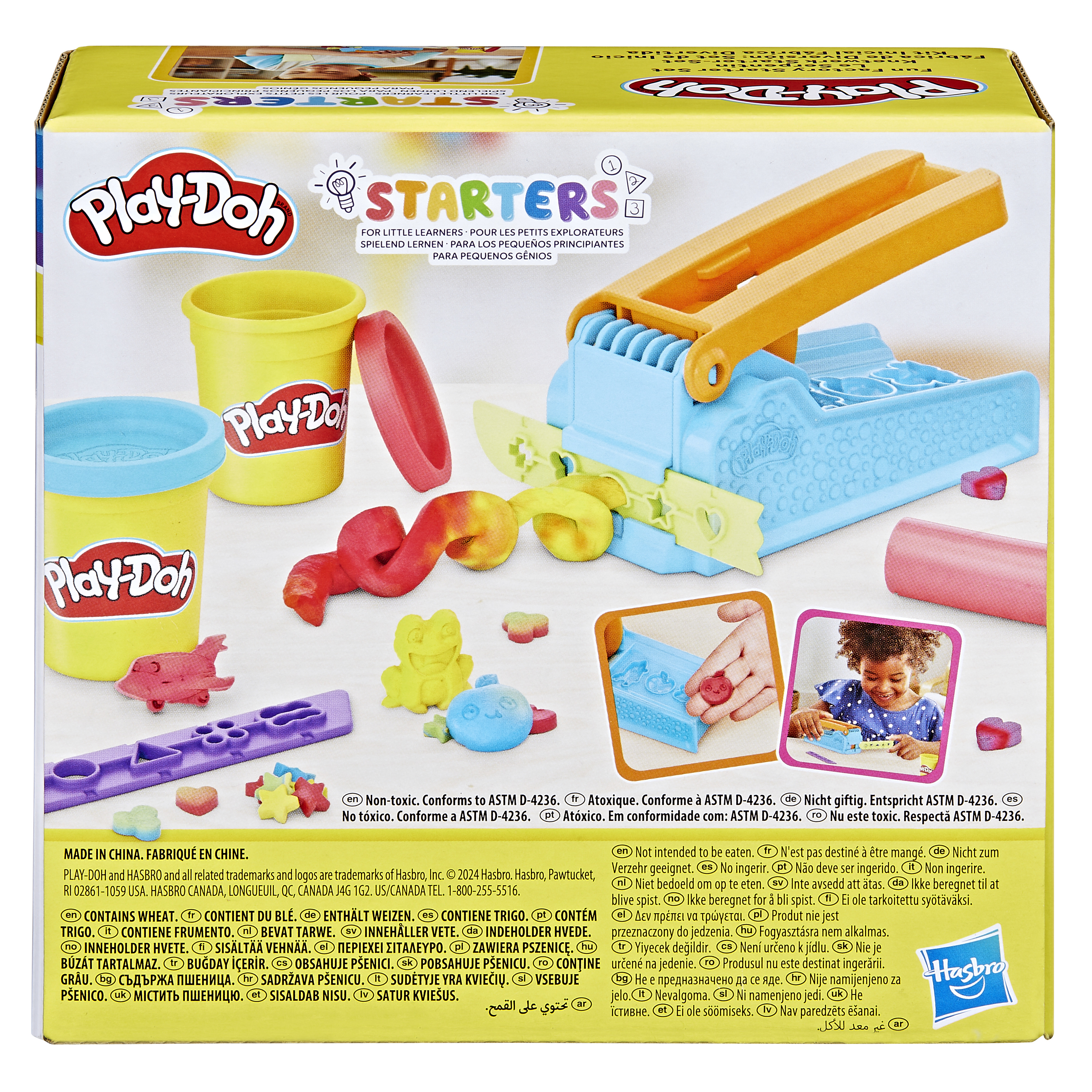 Caja de kit Play-Doh con plastilina, herramientas y un niño usándolas.
