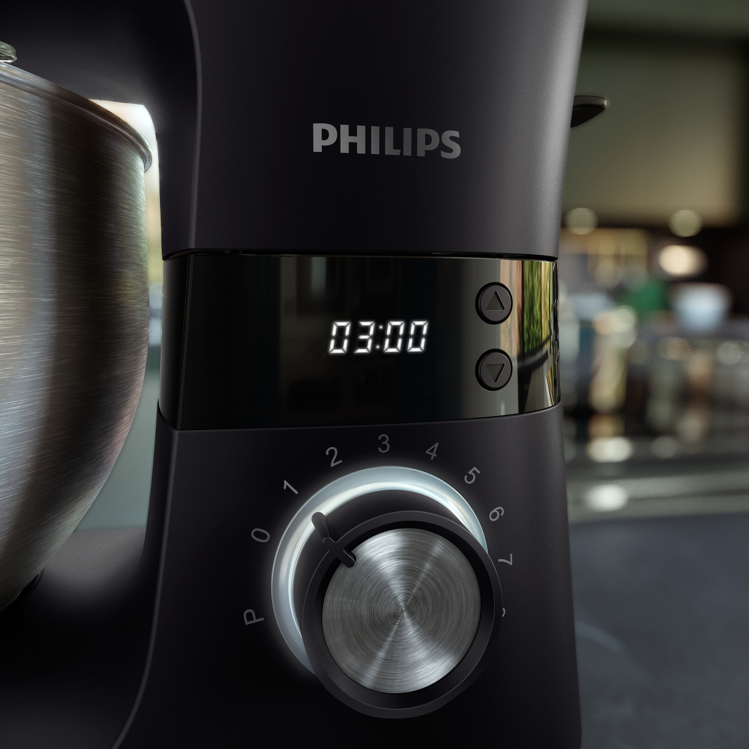 Nahaufnahme eines schwarzen Philips-Küchengeräts. Es hat einen Timer mit 03:00, einen Drehregler und eine Edelstahlschüssel.
