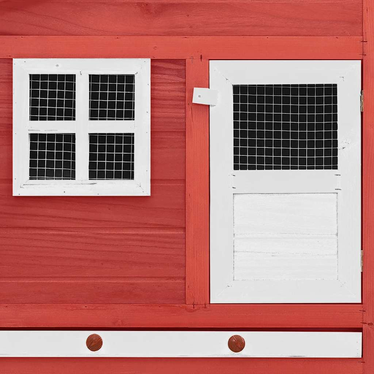 Eine rote Holzstruktur mit einem weißen Fenster und einer Tür. Beide haben Drahtgitter. Unten sind hölzerne Knöpfe zu sehen.