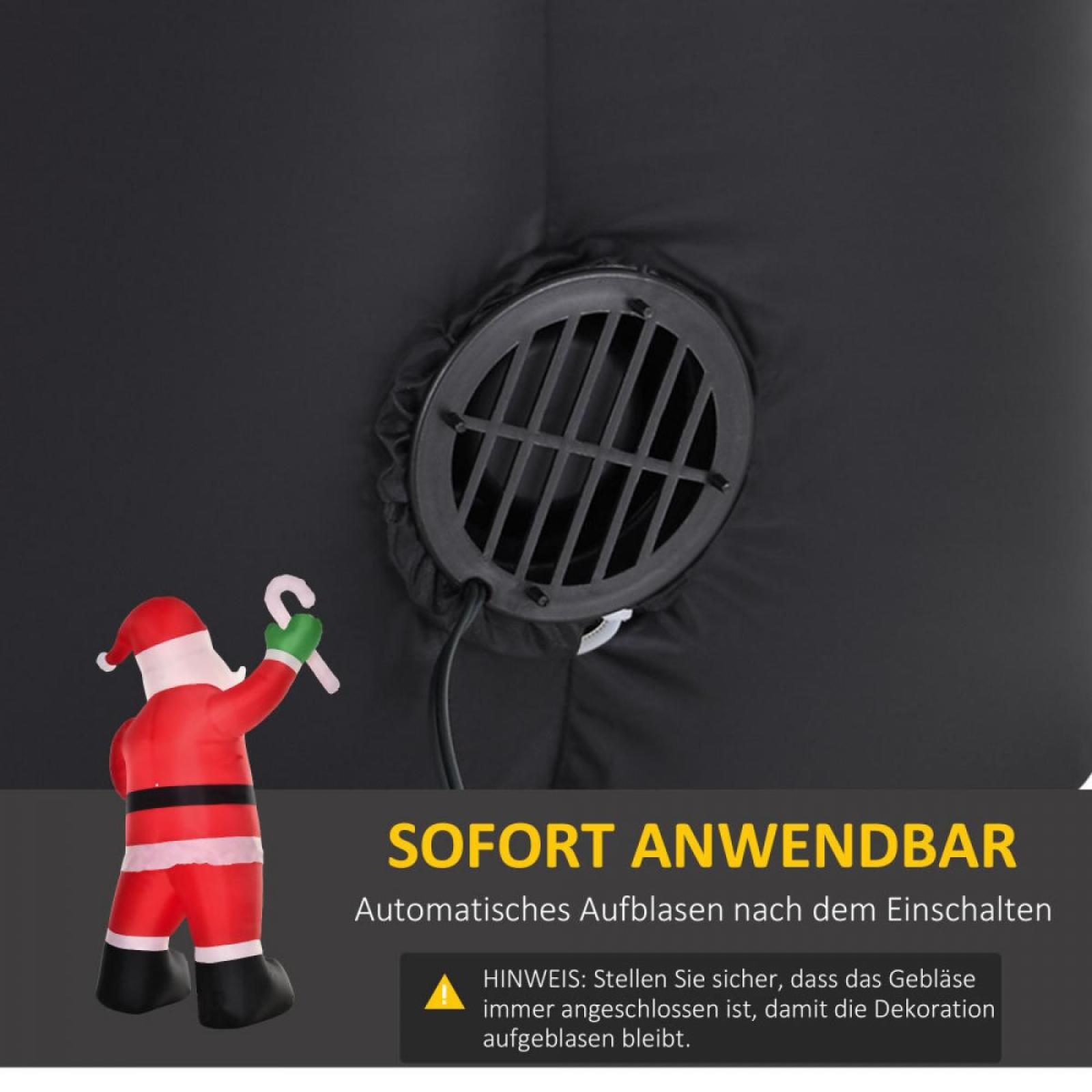 Ein aufblasbarer Weihnachtsmann mit Zuckerstange steht neben einem dunklen Ventilator. Text: SOFORT ANWENDBAR.