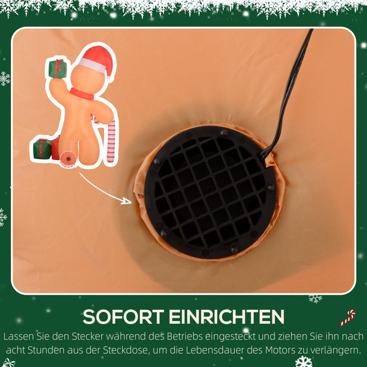 Aufblasbarer Lebkuchenmann mit Geschenken und Zuckerstange. Auf orangefarbenem Hintergrund sind ein Gebläse und ein Netzkabel zu sehen.