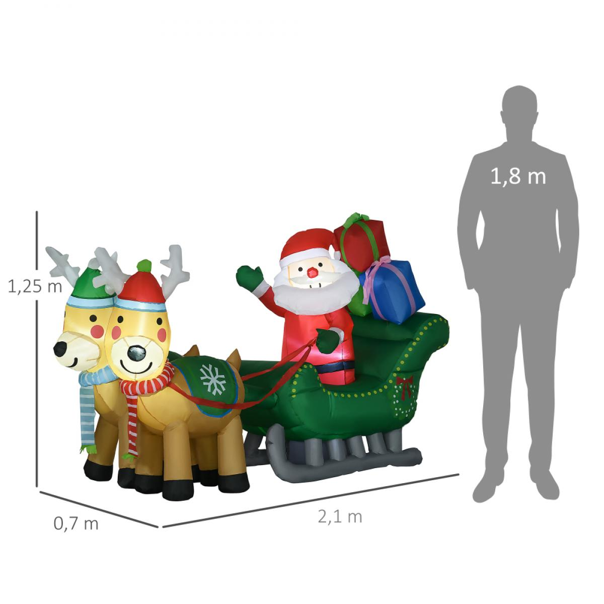 Aufblasbarer Weihnachtsmann in einem Schlitten, der von Rentieren gezogen wird. Der Weihnachtsmann winkt, Geschenke im Schlitten.